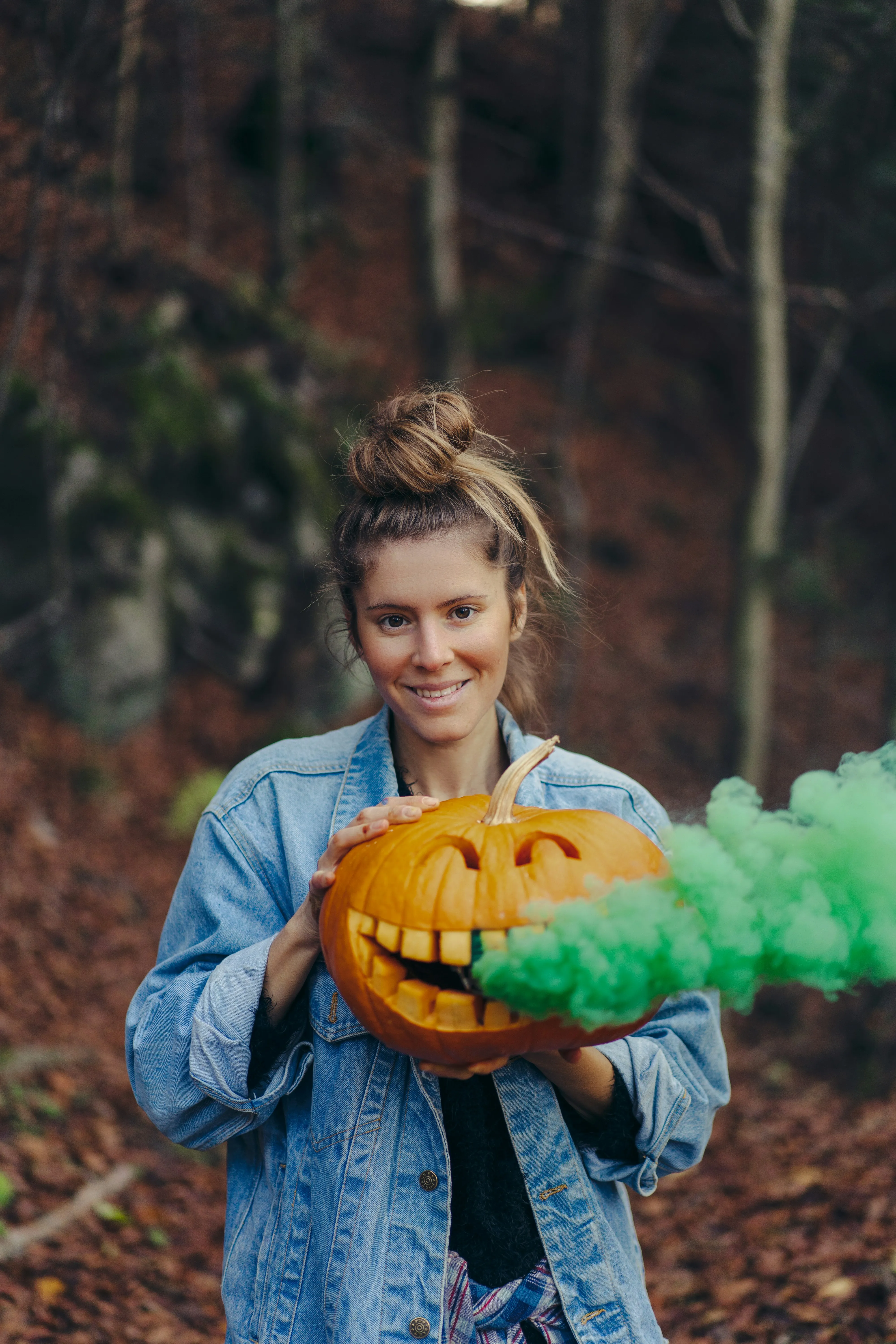Young Woman Holding Pumpkin with Green Smoke Effect Image