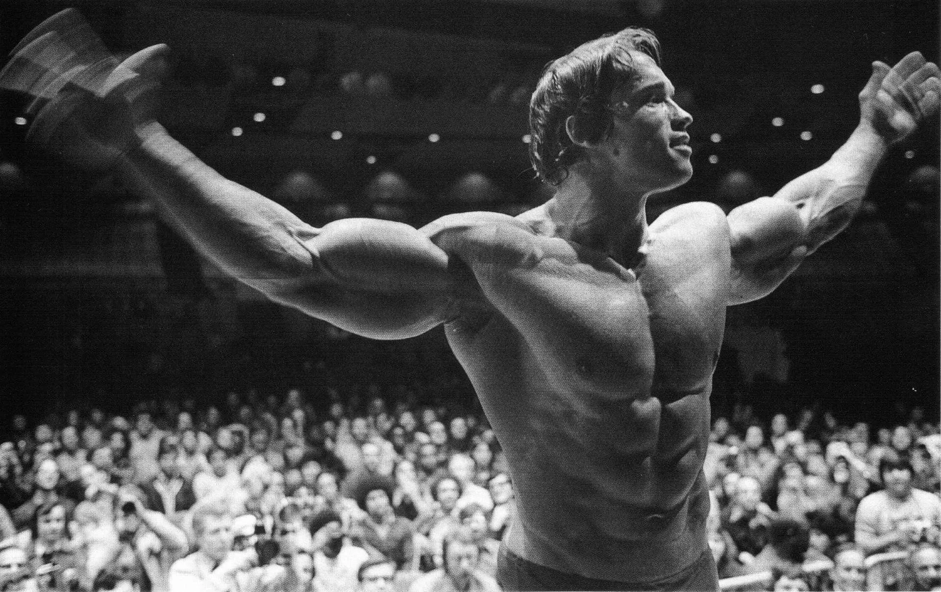 Arnold Flexing Muscles on Stage Black and White Wallpaper