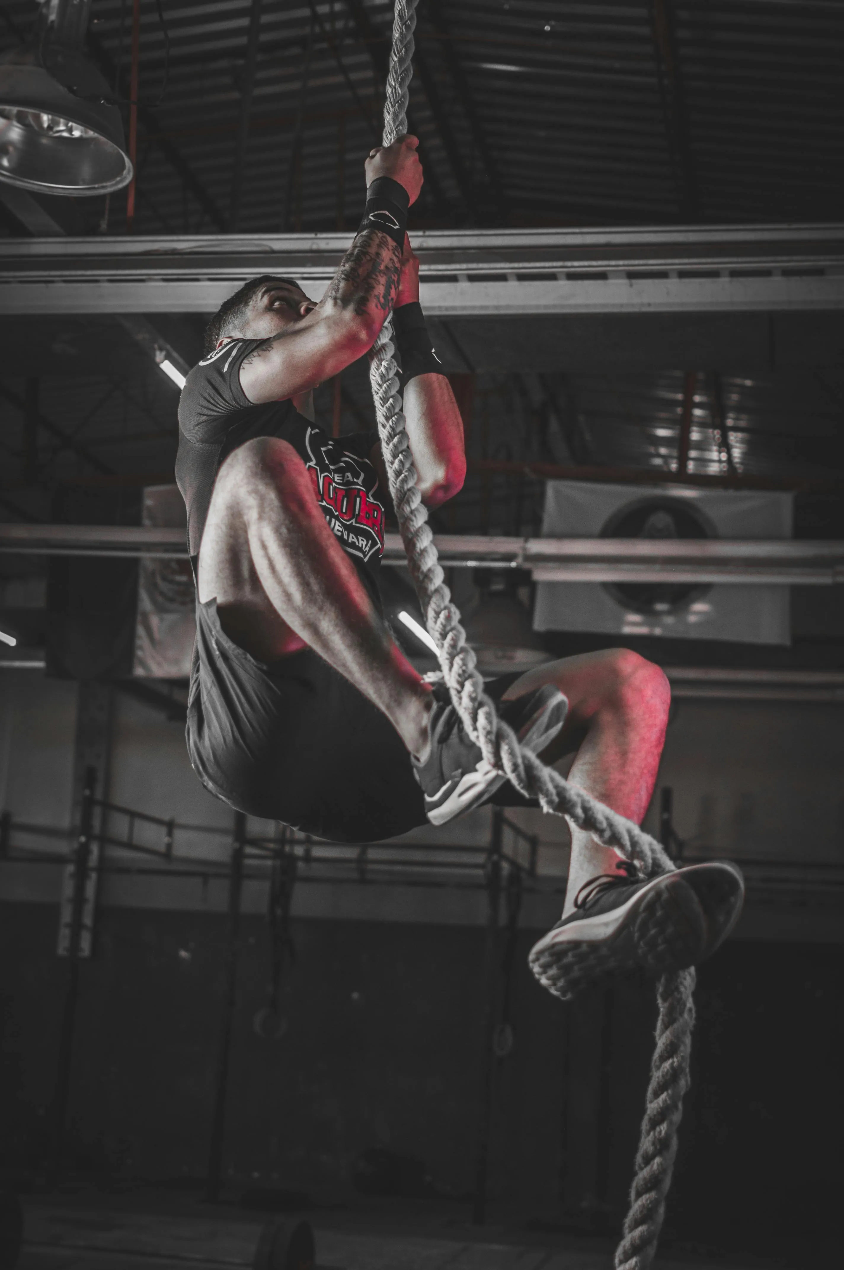 Athlete Climbing a Thick Rope During an Upper Body Challenge