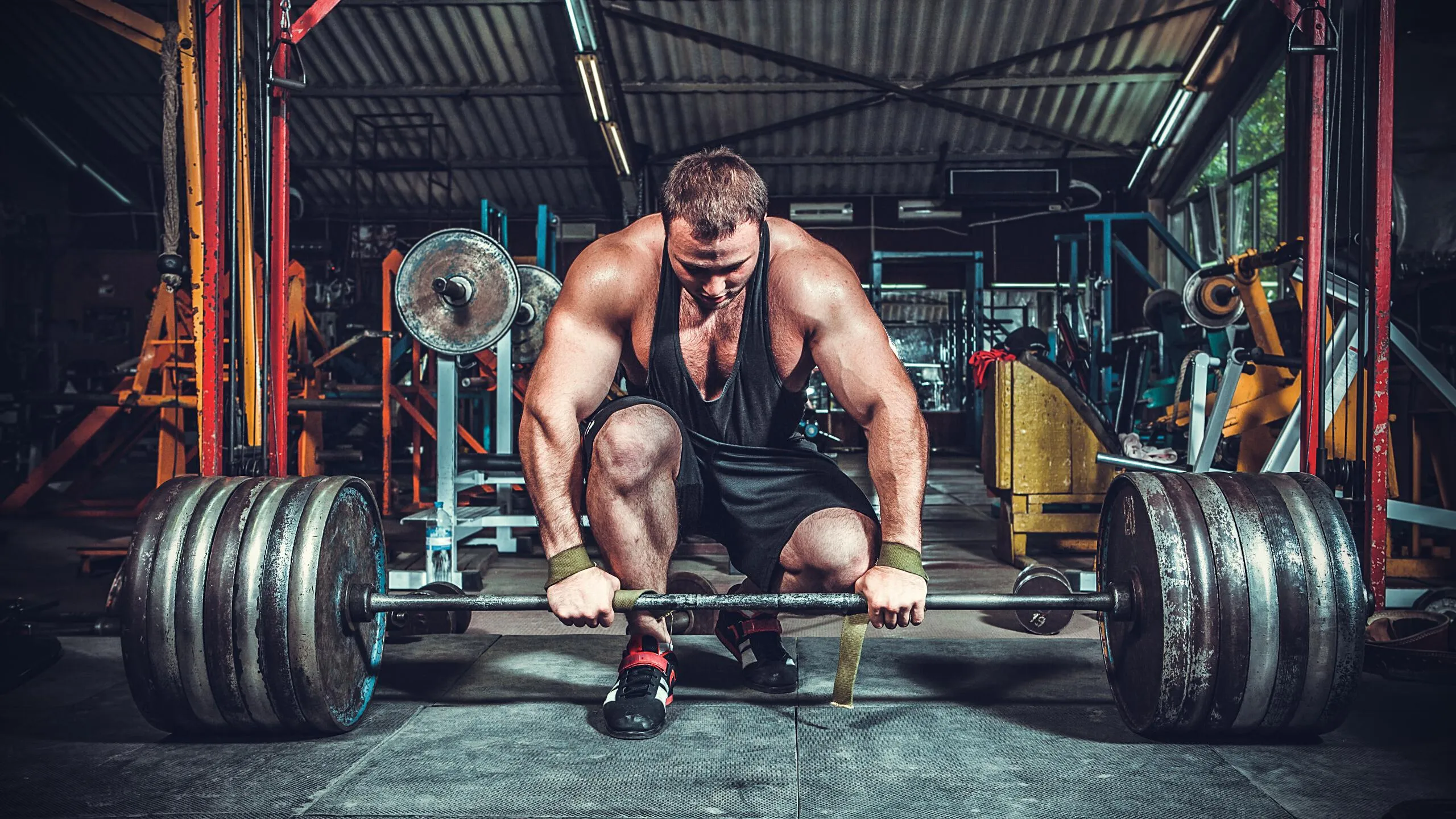 Athlete Setting Up a Heavy Barbell Lift in an Industrial Gym