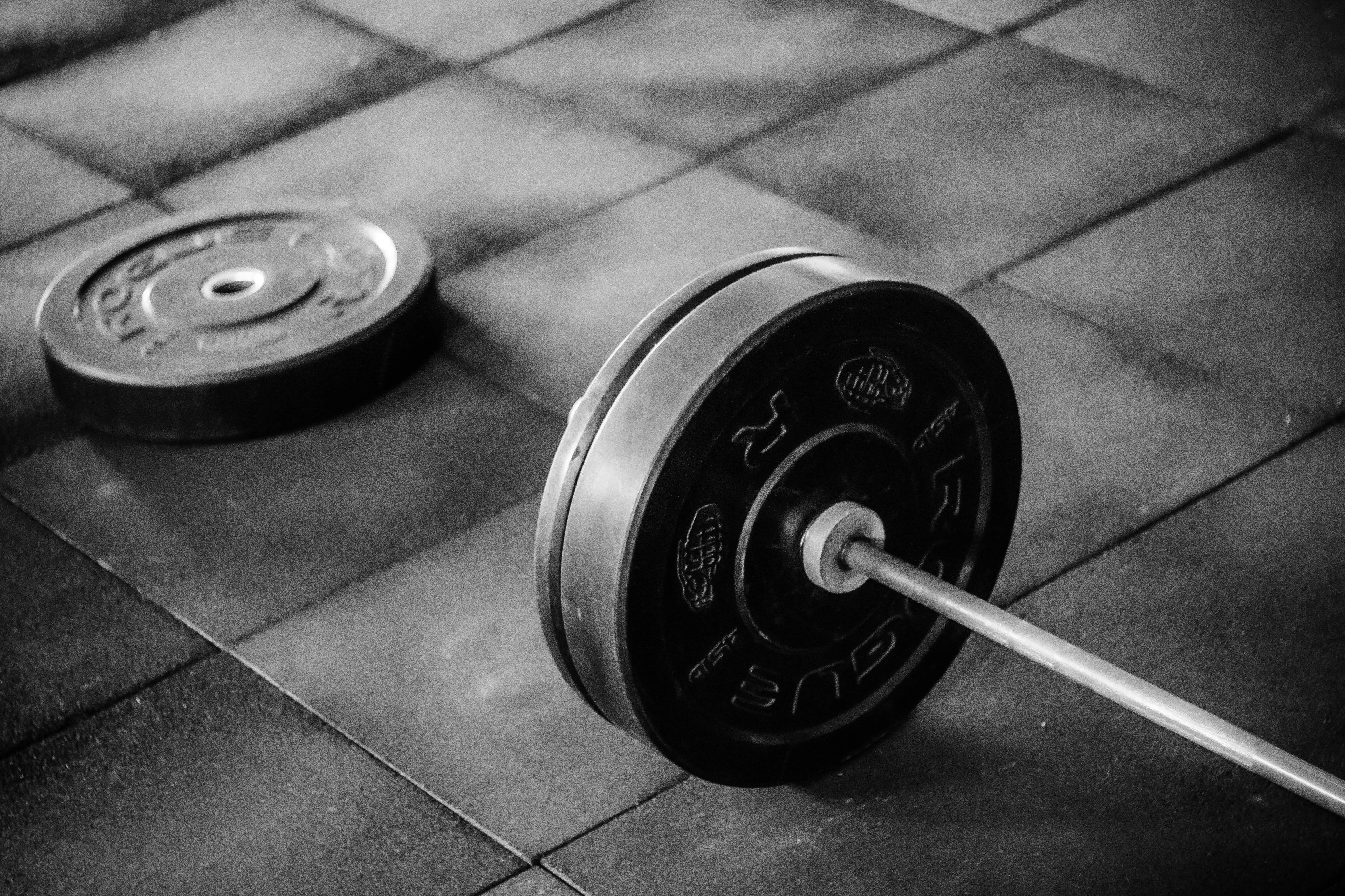 Barbell With Plates Placed on the Gym Floor Free Wallpaper