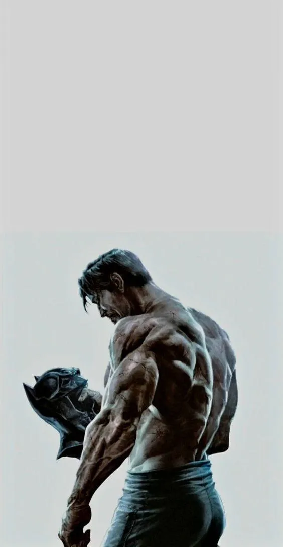 Batman Holding a Black Mask With Dramatic Lighting Wallpaper