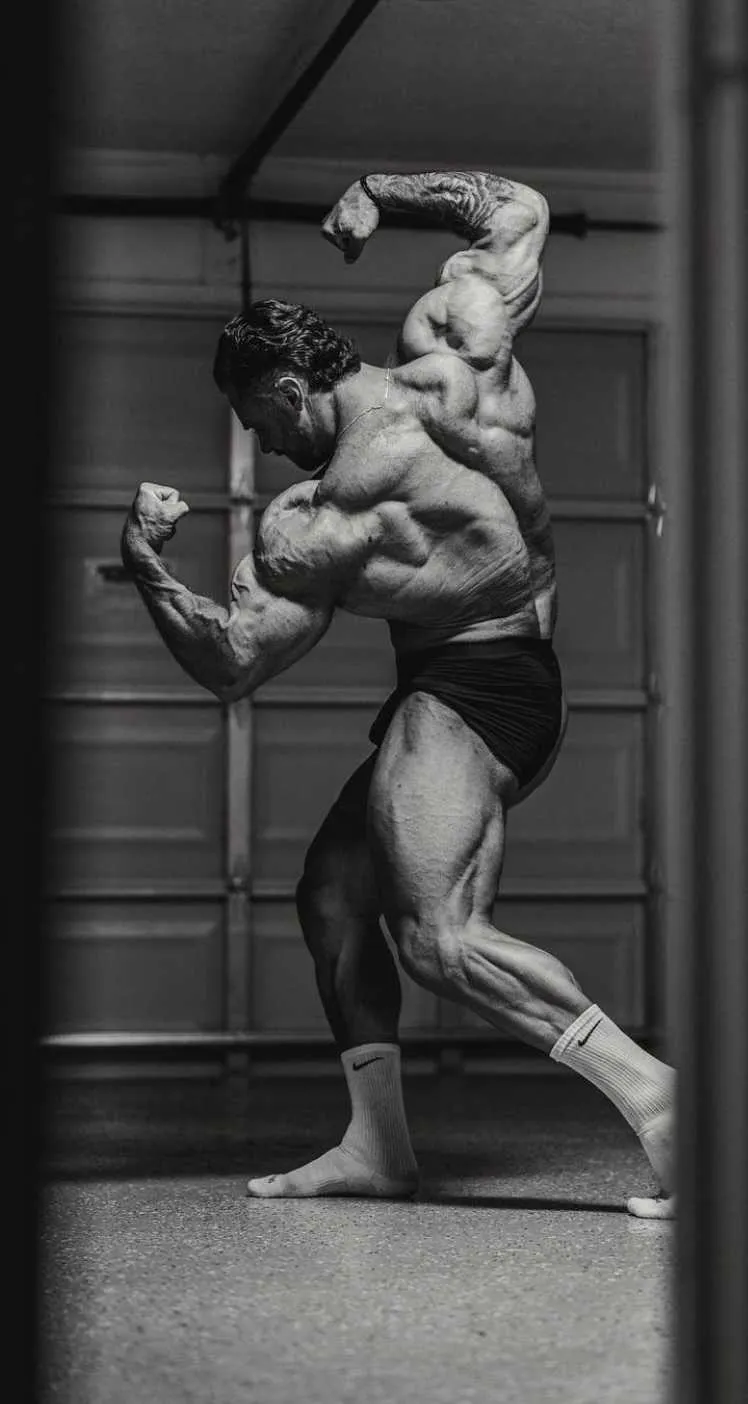 Black and White Photo of a Bodybuilder in a Gym Environment