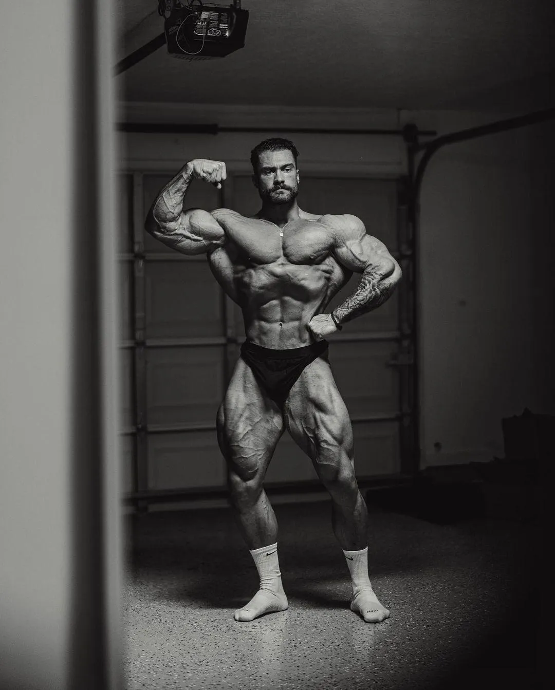 Black and White Photo of a Man in Classic Bodybuilding Pose