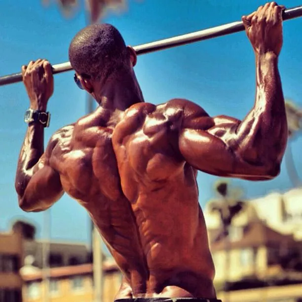 Bodybuilder Doing Overhead Press Outdoors in Sunny Weather