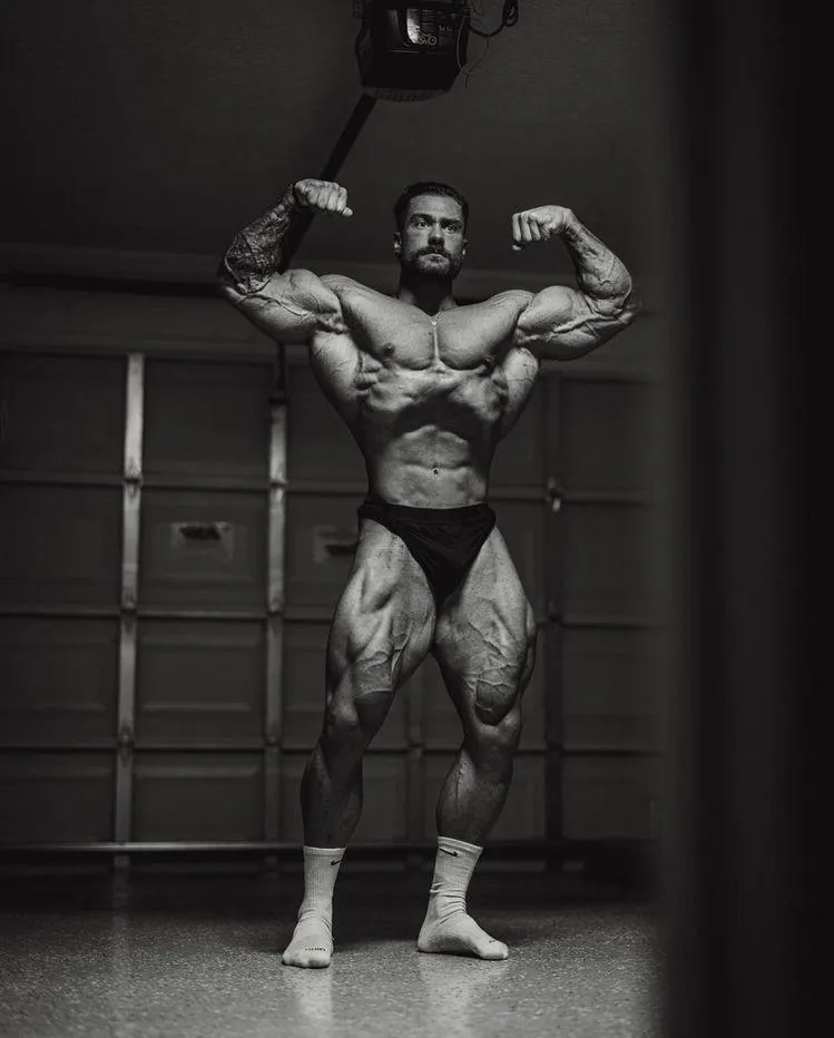 Bodybuilder Posing Indoors Showing Massive Upper Body Gains