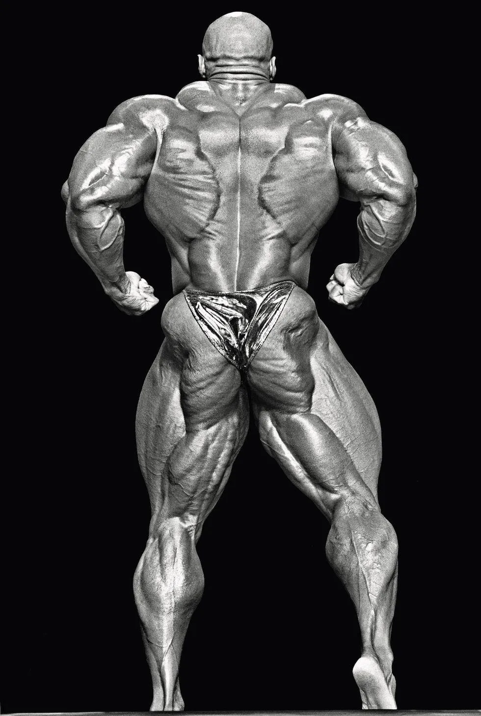 Bodybuilder Posing Showing Muscular Back and Legs Wallpaper