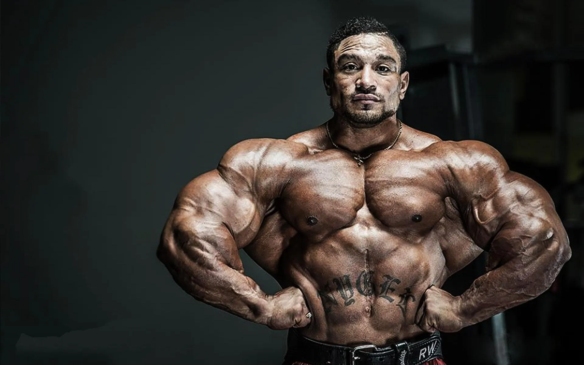 Bodybuilder Showing Massive Chest and Arms With Confidence