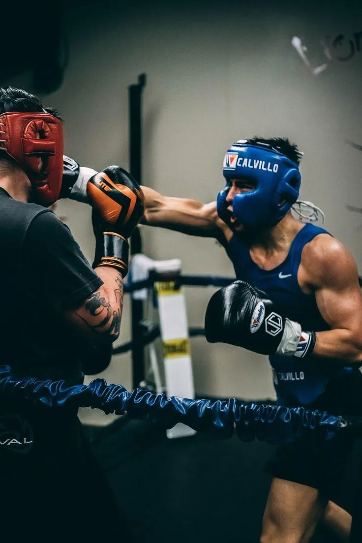 Boxers Training and Sparring Inside a Ring With a Coach