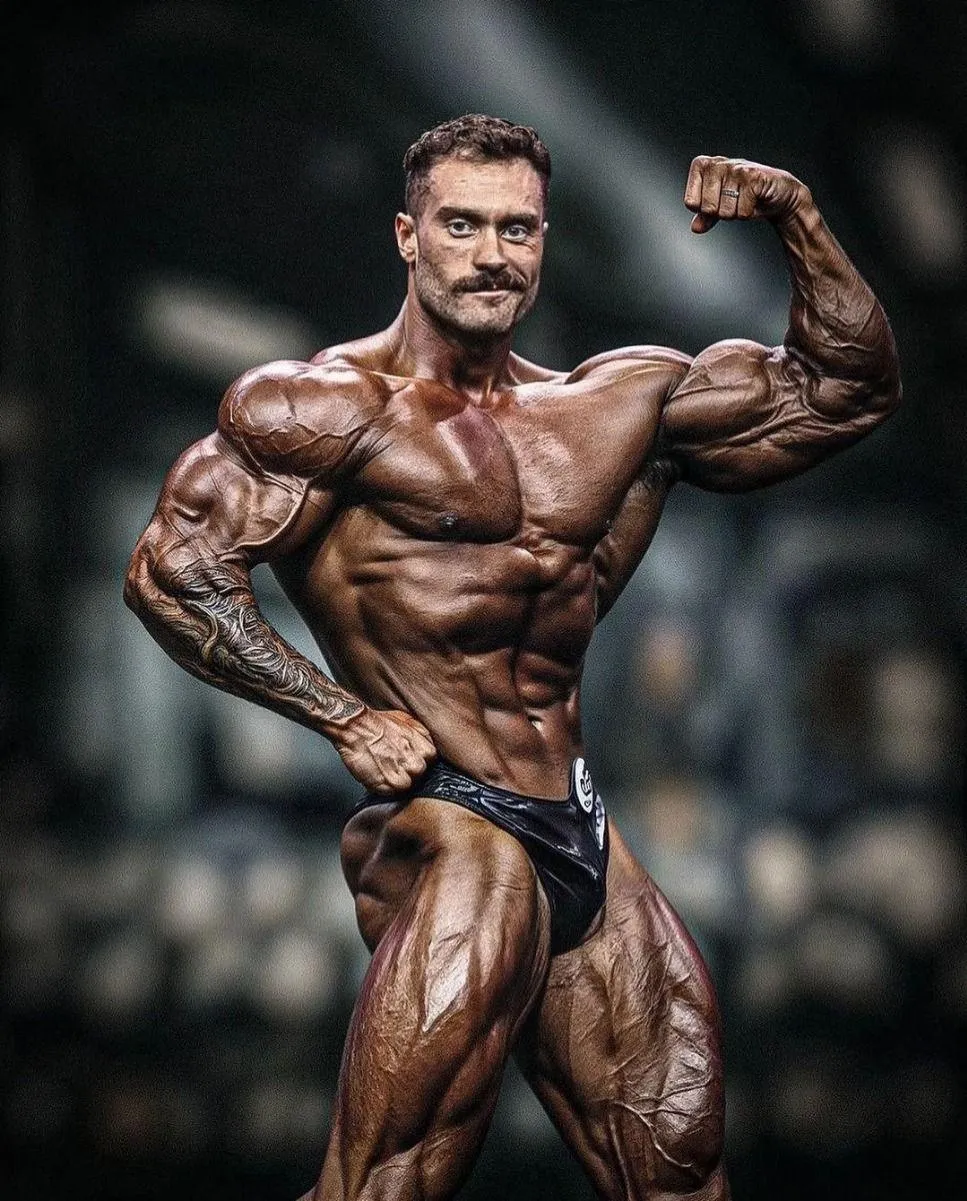 Chris Bumstead Flexing Muscles During a Professional Show