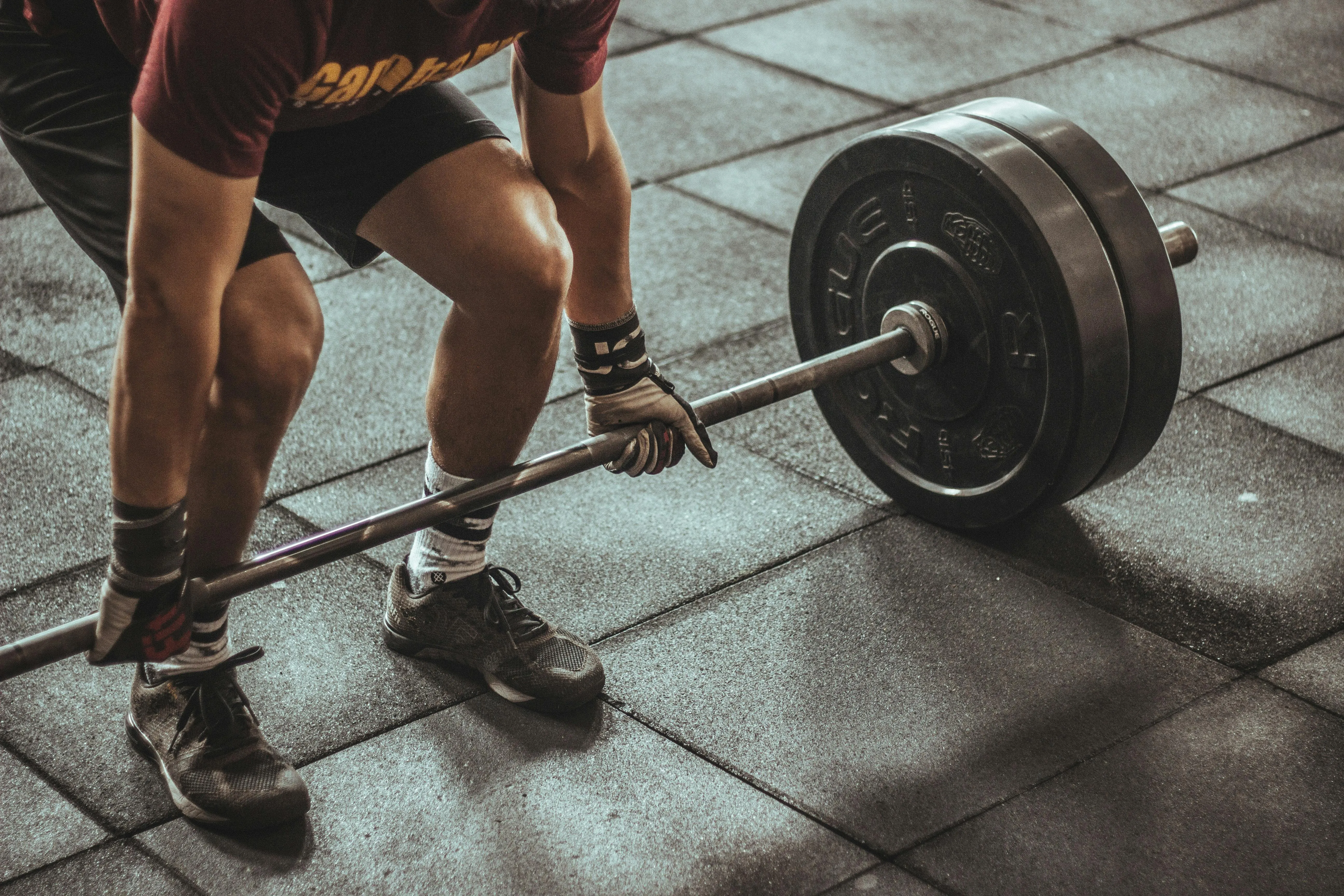 Close Up of Legs Lifting a Barbell During a Gym Deadlift Set