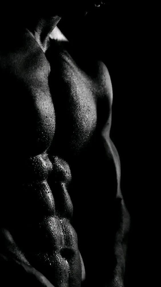 Close Up of Muscular Male Torso in Dramatic Shadow Lighting