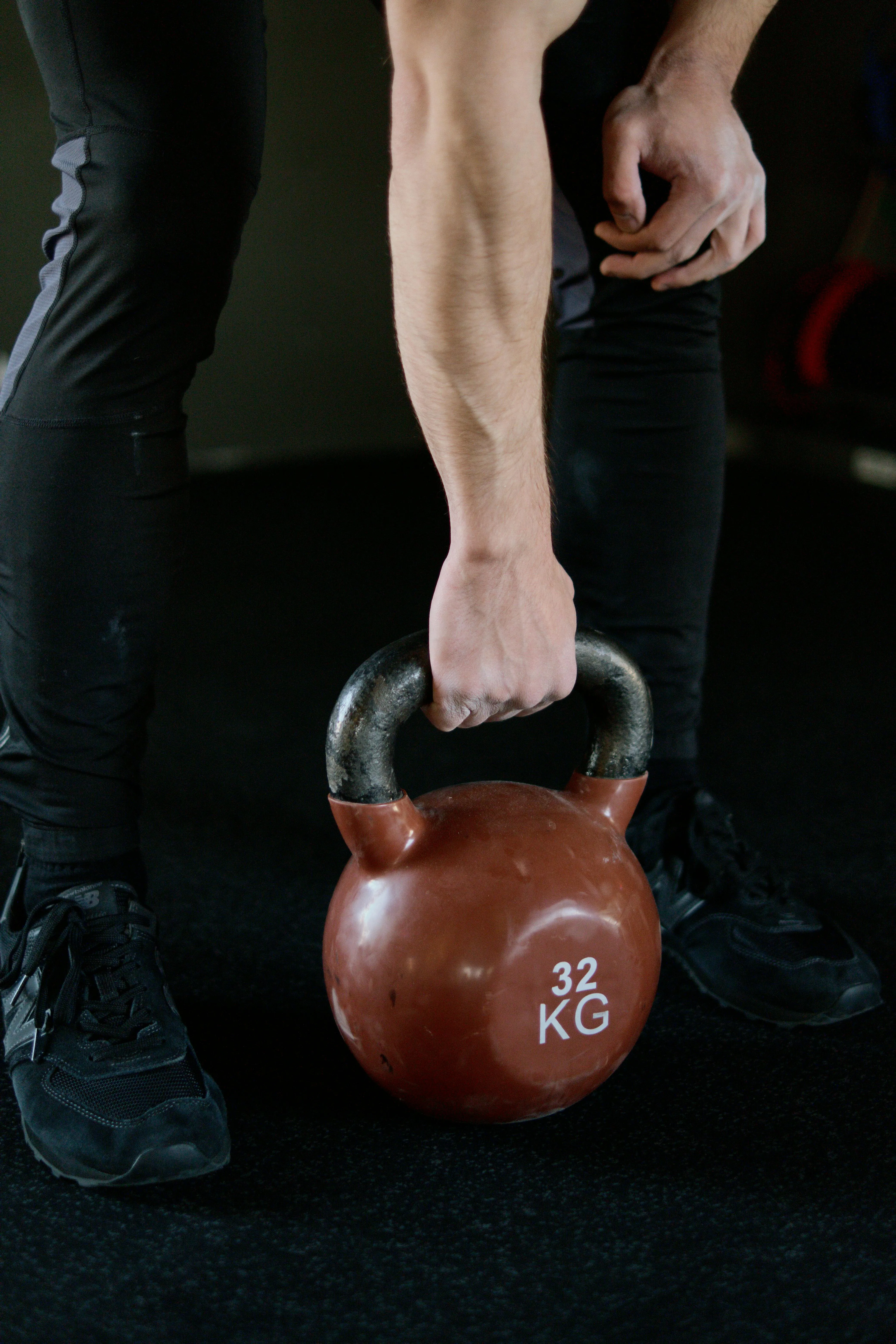 Close Up of Person Holding Kettlebell For Gym Training