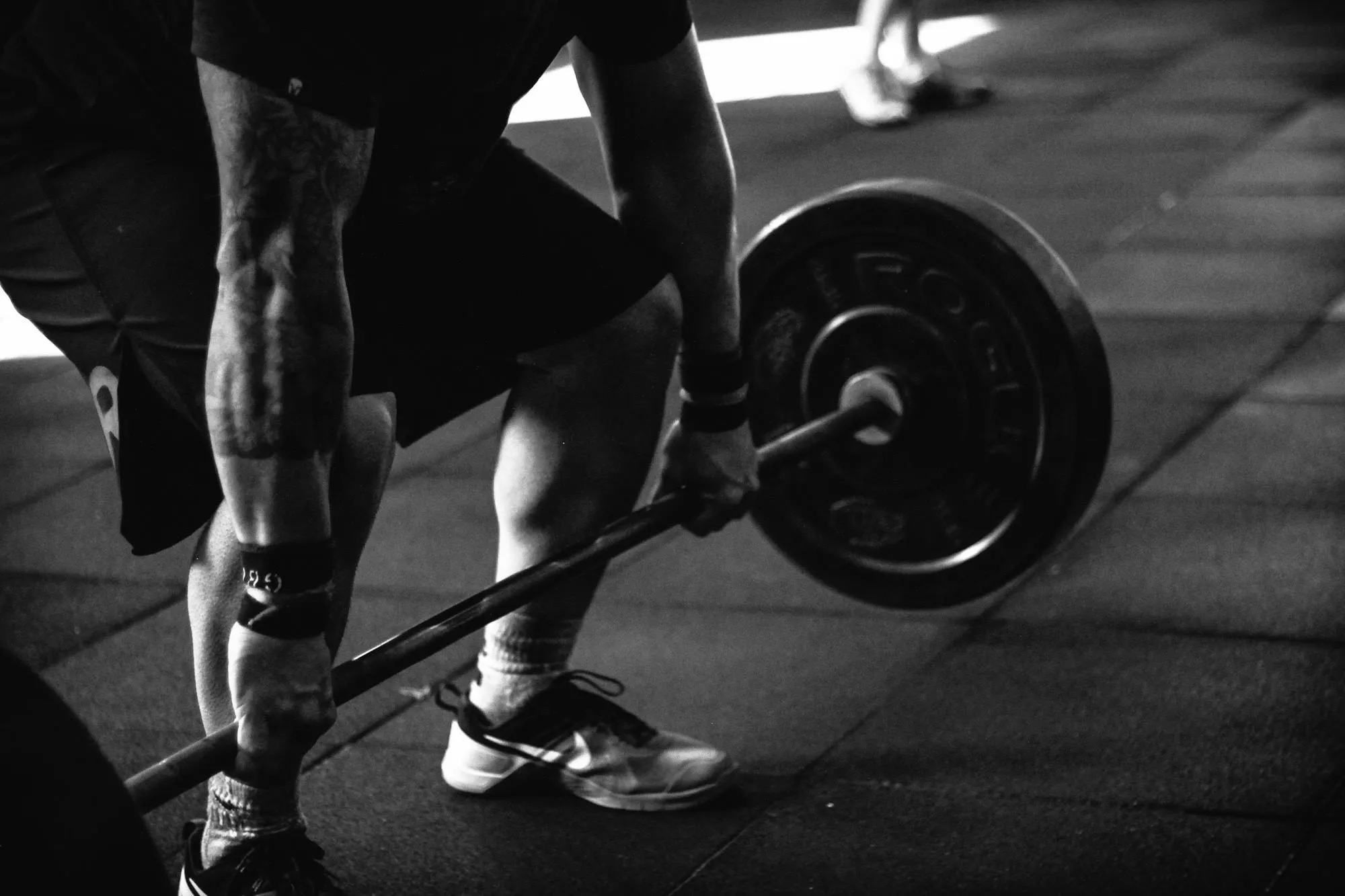 Close Up of a Person Lifting Barbell For Deadlift Reps