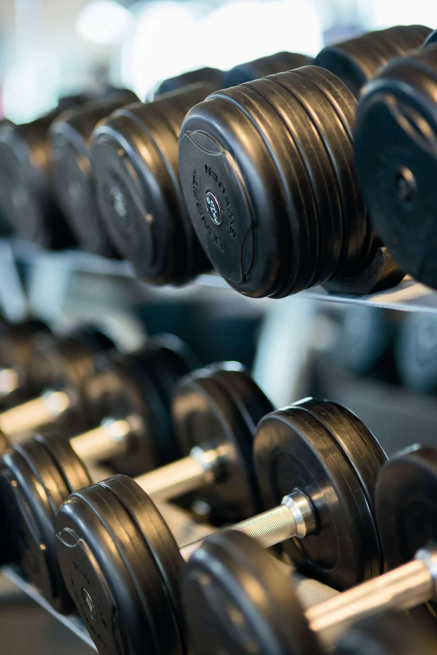 Close Up View of Black Dumbbells Stacked on a Gym Rack