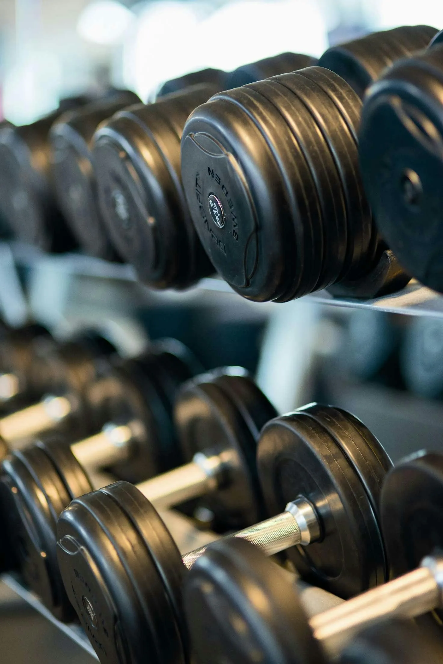 Close Up View of Dumbbells Stacked Neatly on a Metal Rack