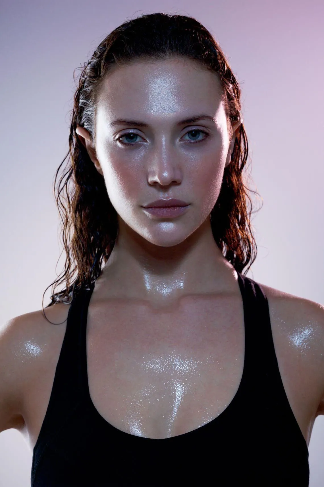 Confident Woman With Wet Hair Wearing a Black Workout Top