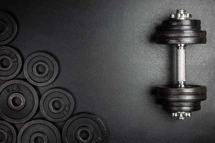 Dumbbells and Weight Plates on a Floor Desktop Wallpaper