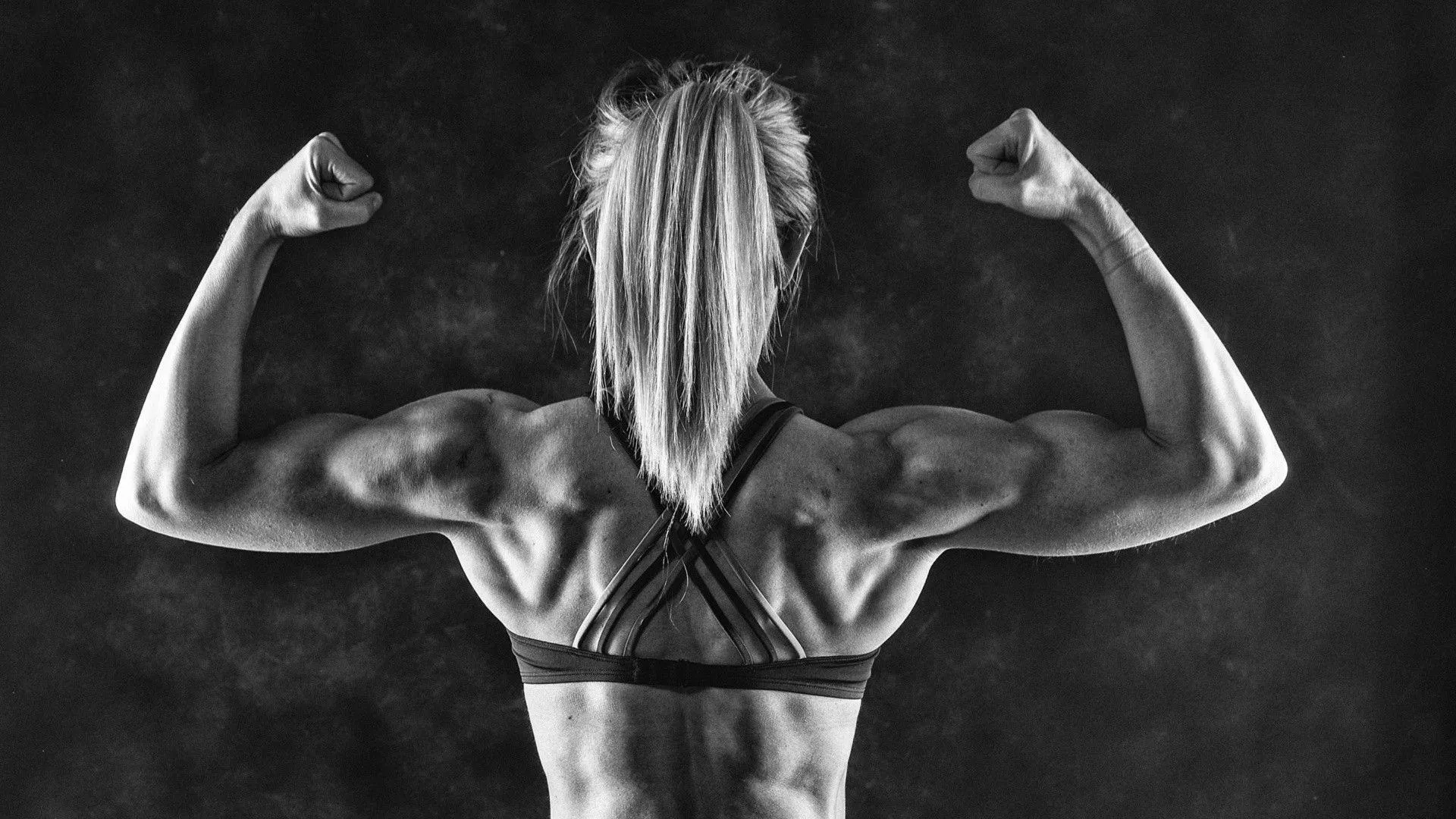 Female Bodybuilder Showing Back Muscles in Black and White