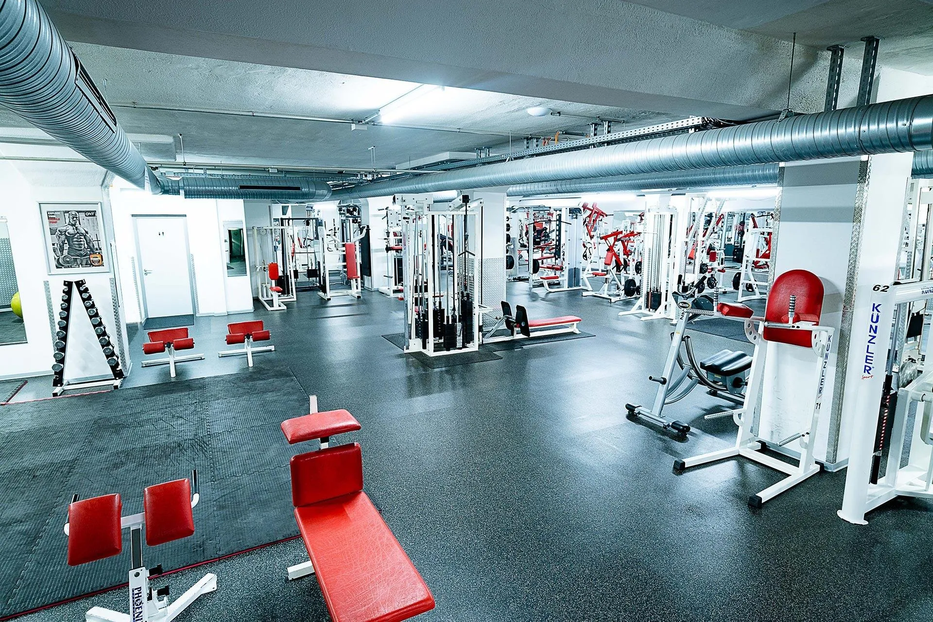 Fitness Center With Red Benches and Machines Free Wallpaper