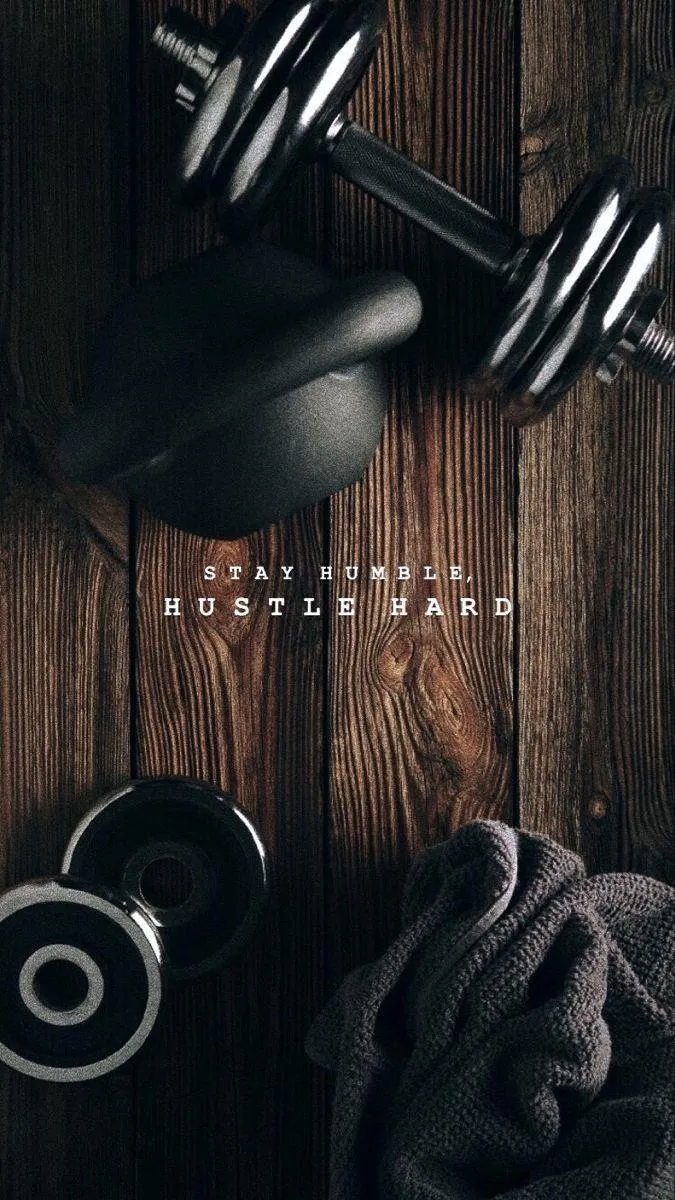 Flat Lay of Dumbbells and Gear on a Dark Wooden Surface