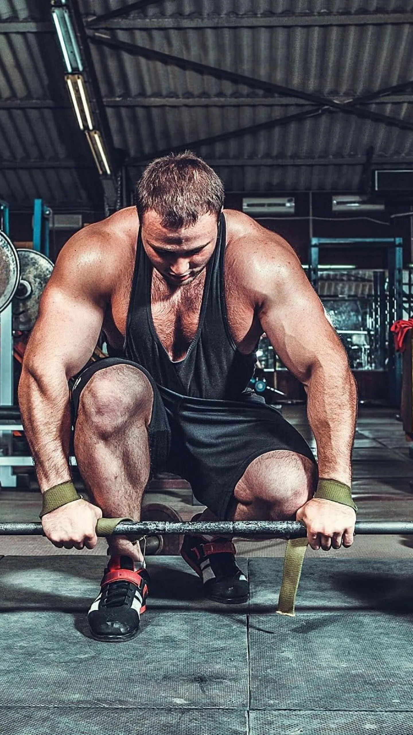Focused Man Preparing For a Heavy Barbell Lift in the Gym