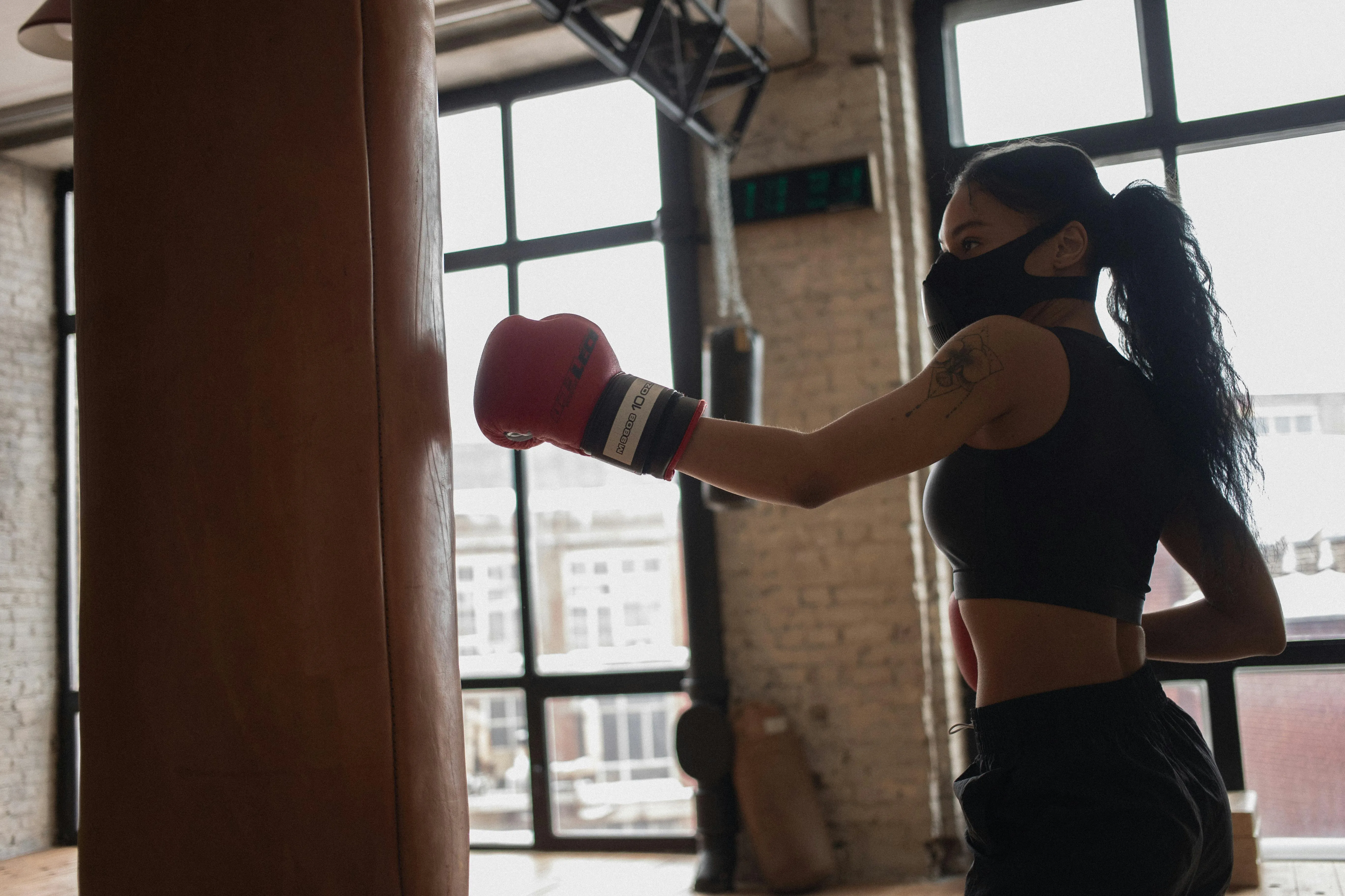 Focused Women Boxing With Gloves At an Indoor Training Space