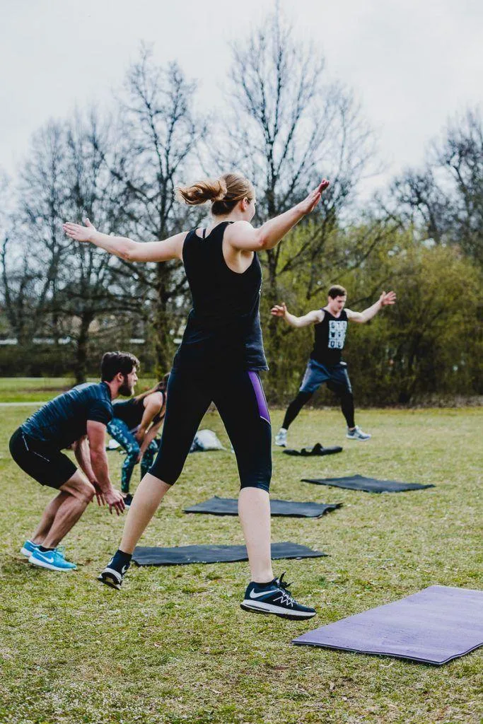 Group Fitness Training Outdoors With Stretching Exercises