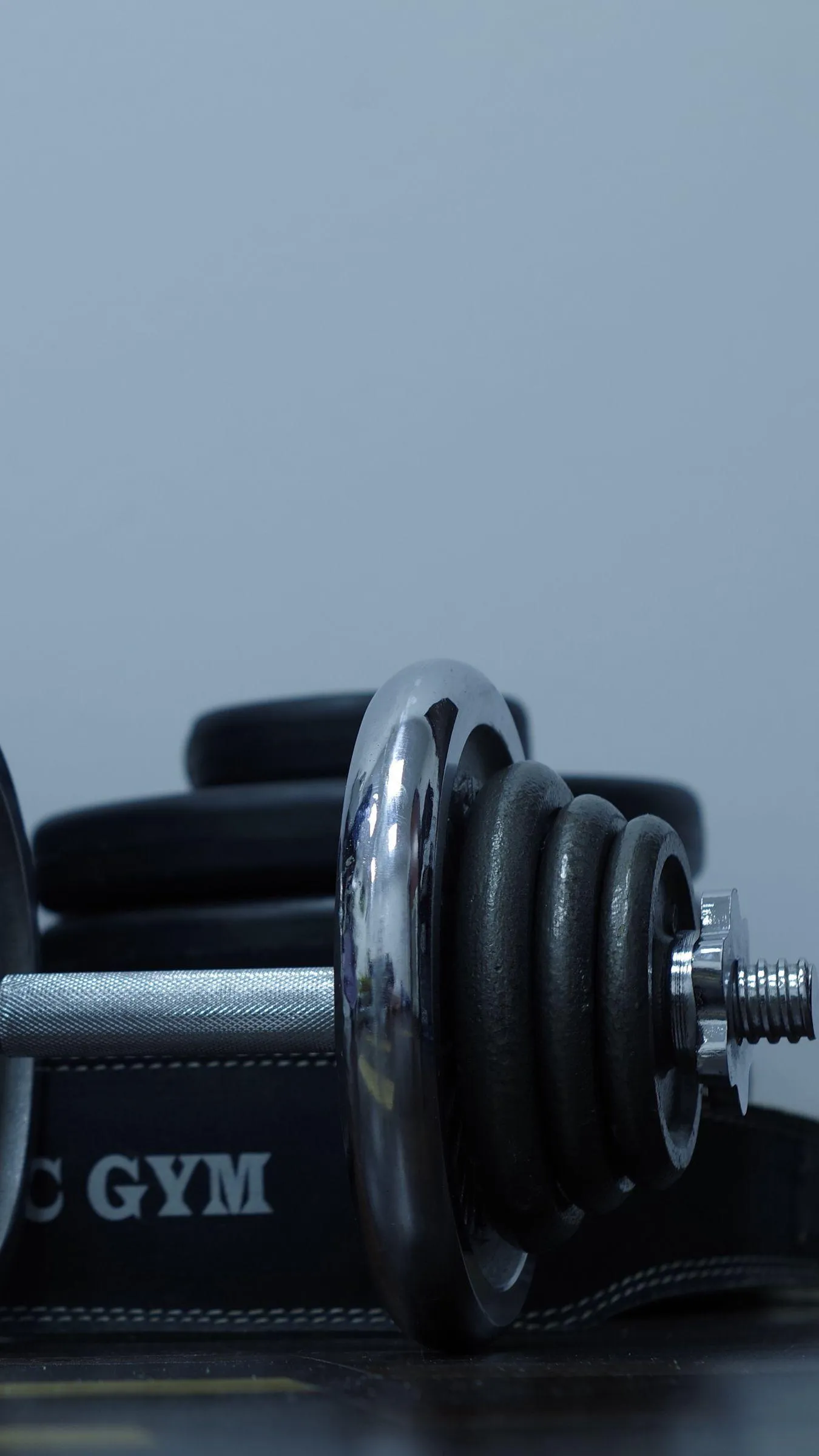 Gym Barbell Resting on the Floor Free Portrait Wallpaper