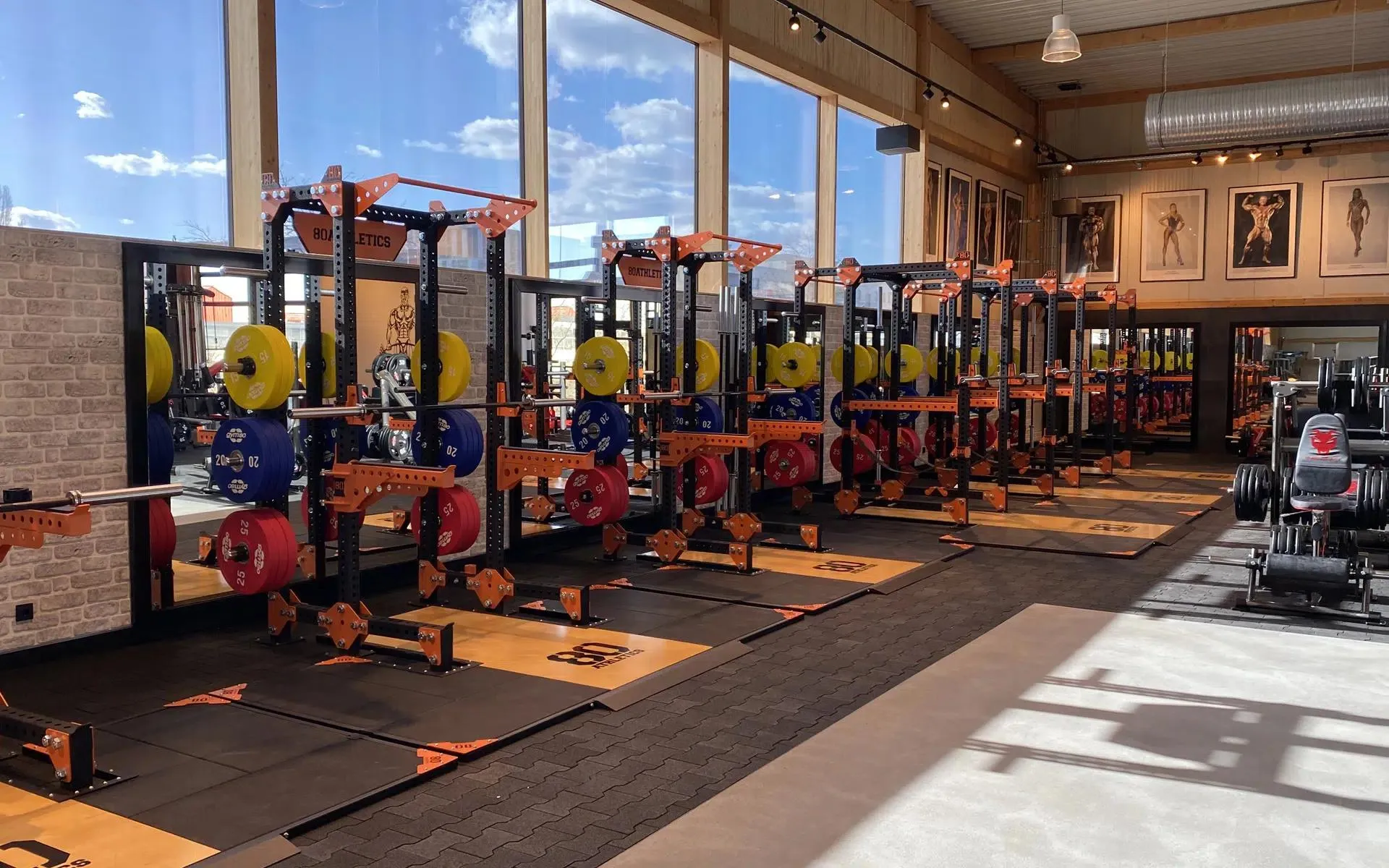 Gym With Orange Interior and Workout Machines Free Wallpaper