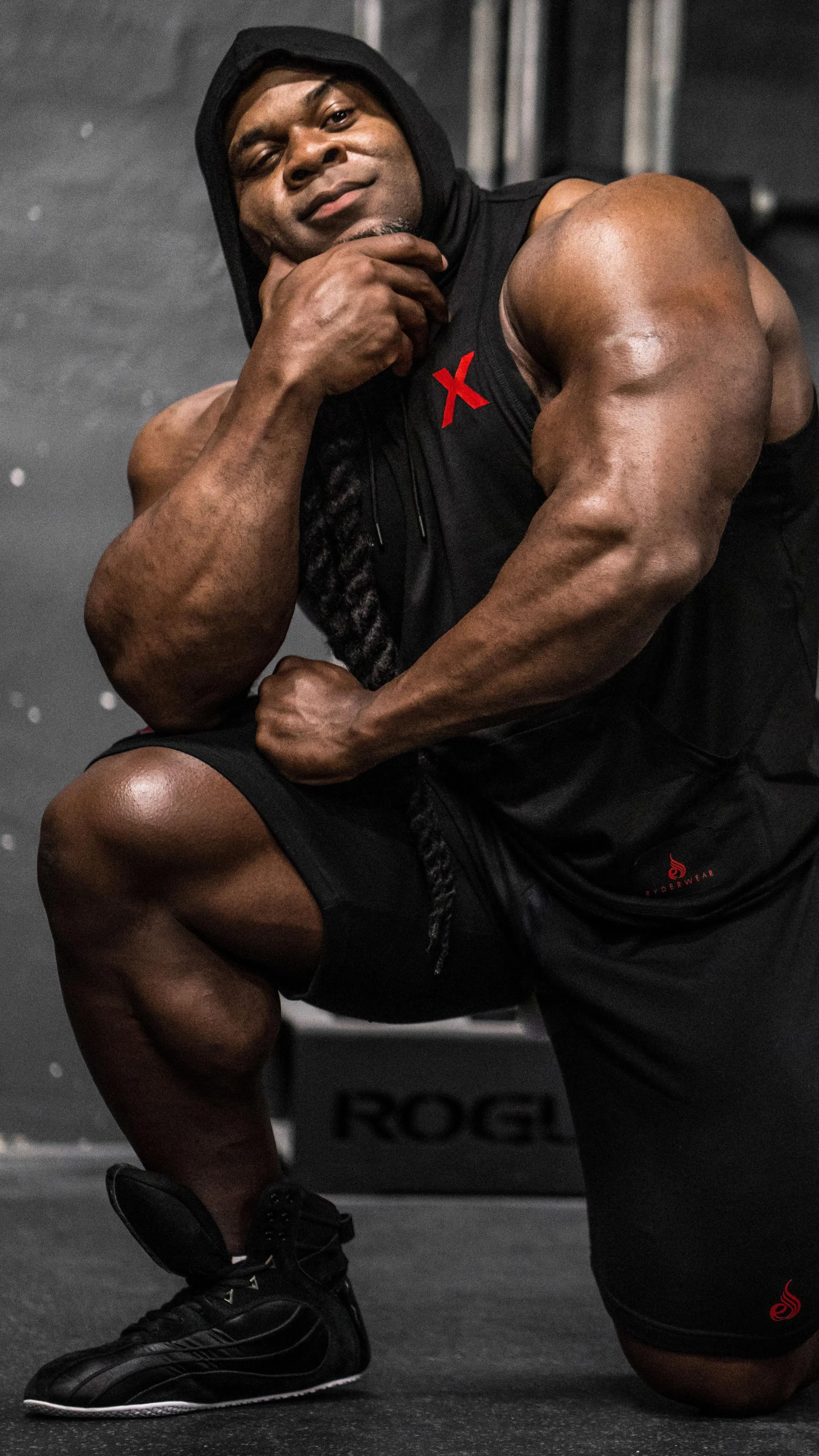 Kai Greene Showing Muscle in the Gym Environment Wallpaper