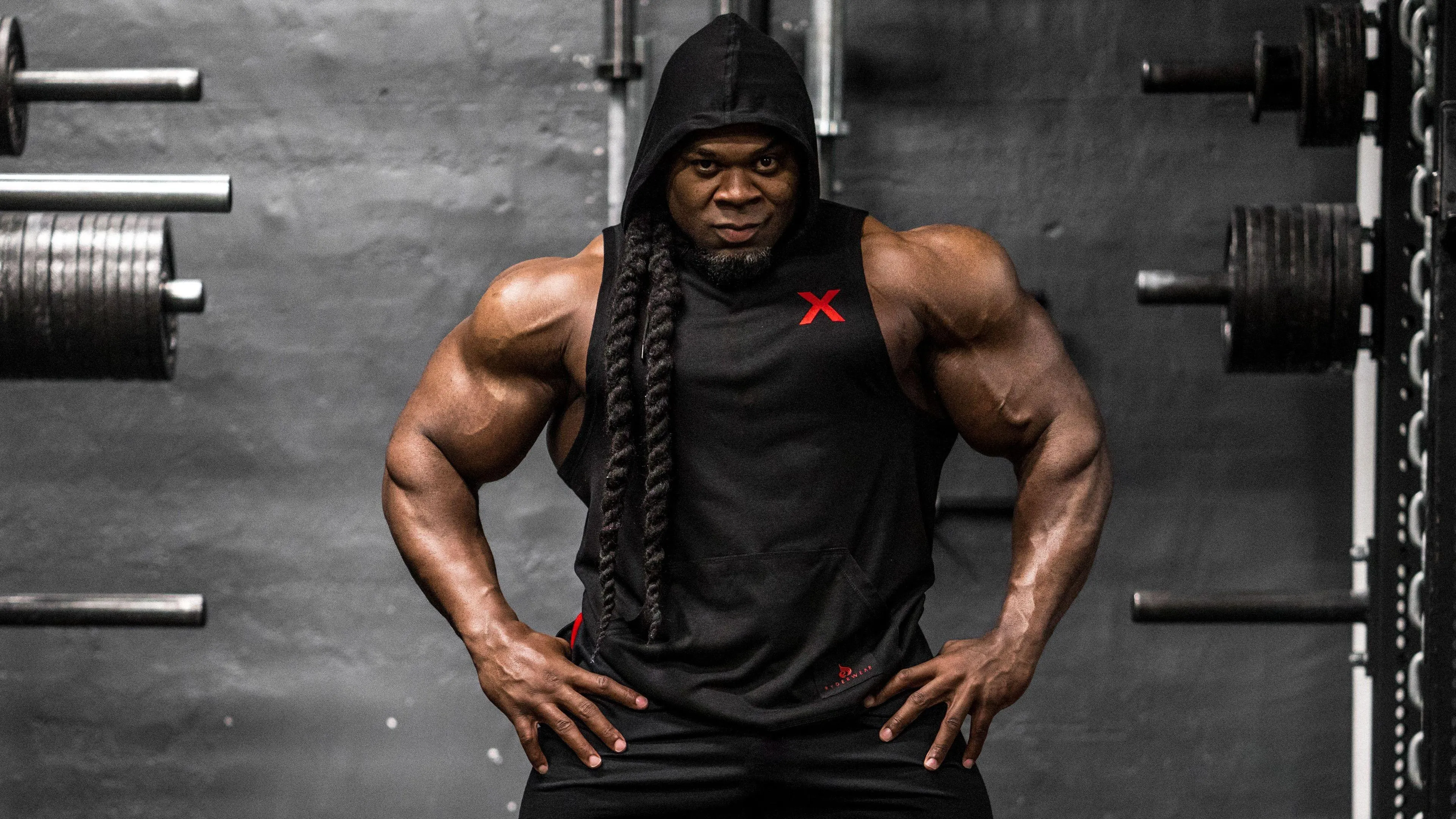Kai Greene Standing Confidently in the Gym Free Wallpaper