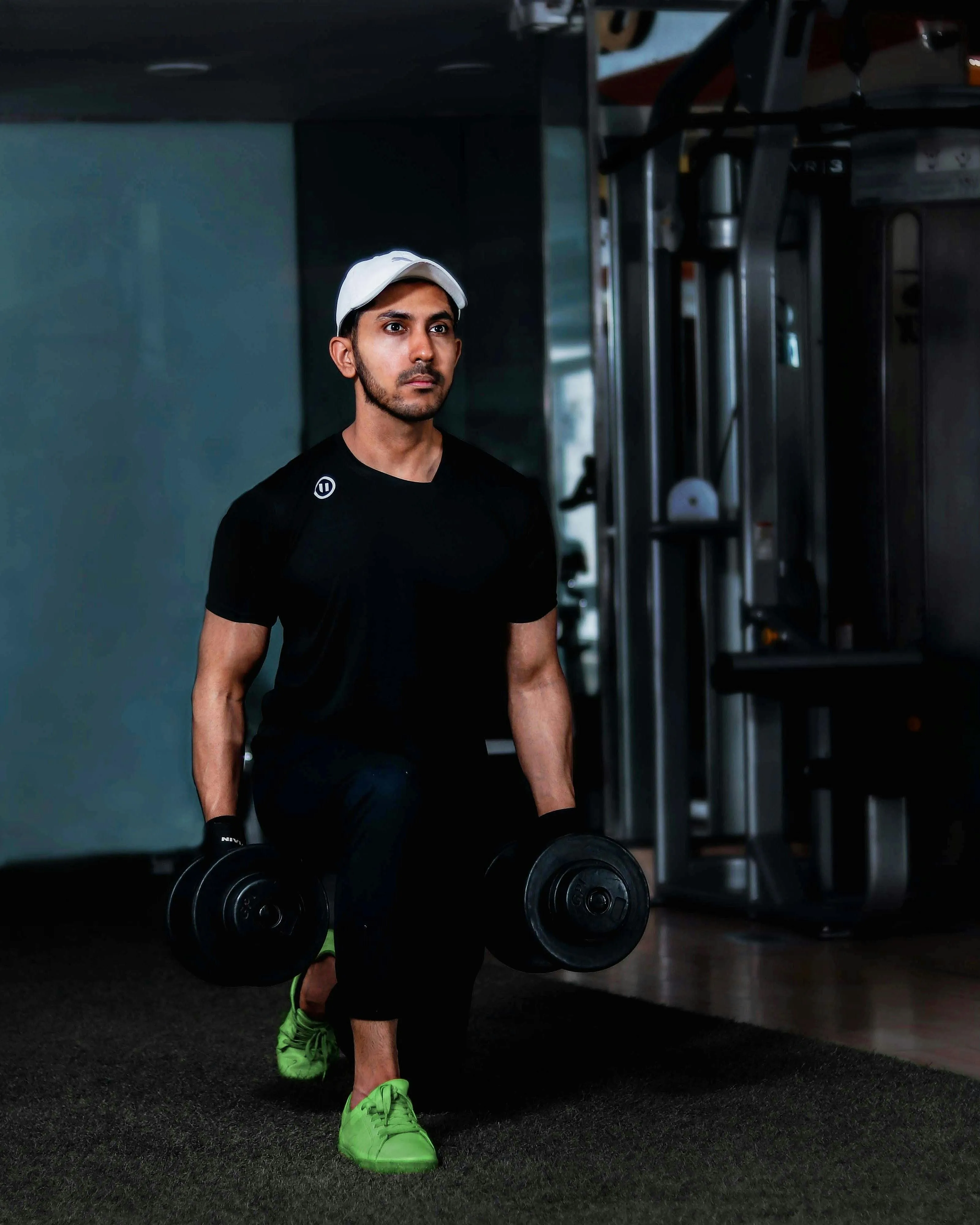 Man Doing Dumbbell Lunges During an Indoor Strength Workout
