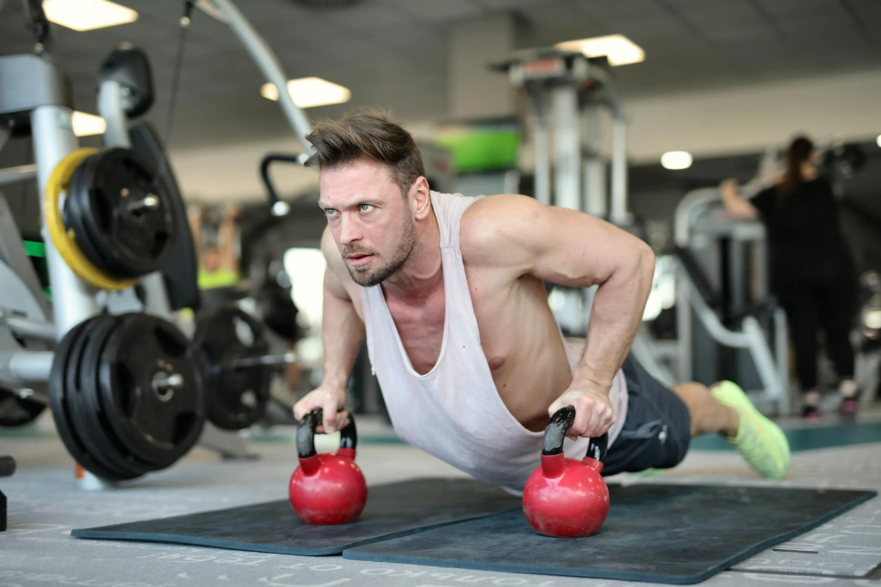 Man Doing Push Ups on Kettlebells For Added Challenge