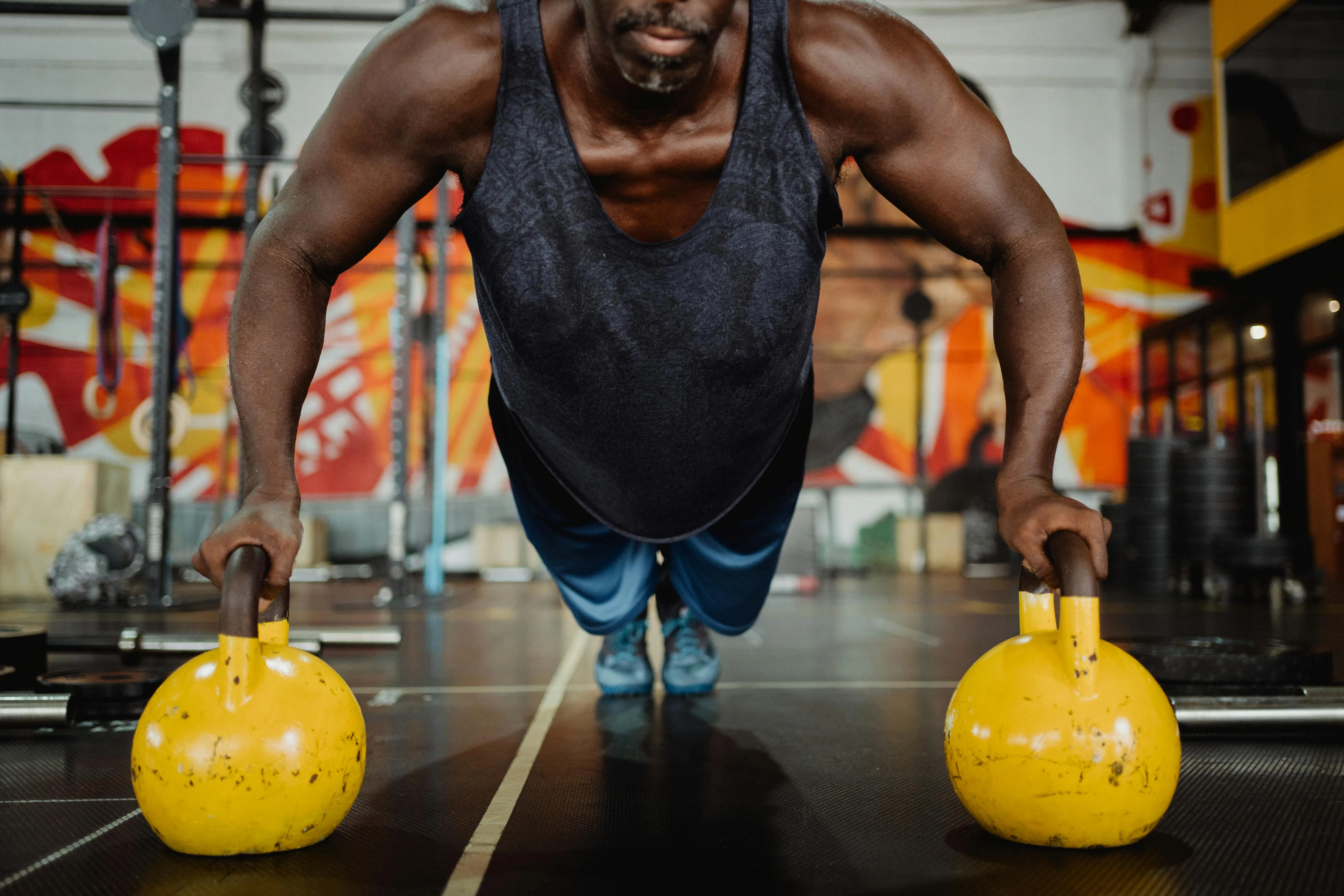 Man Doing Pushups on Kettlebells With a Great Upper Body