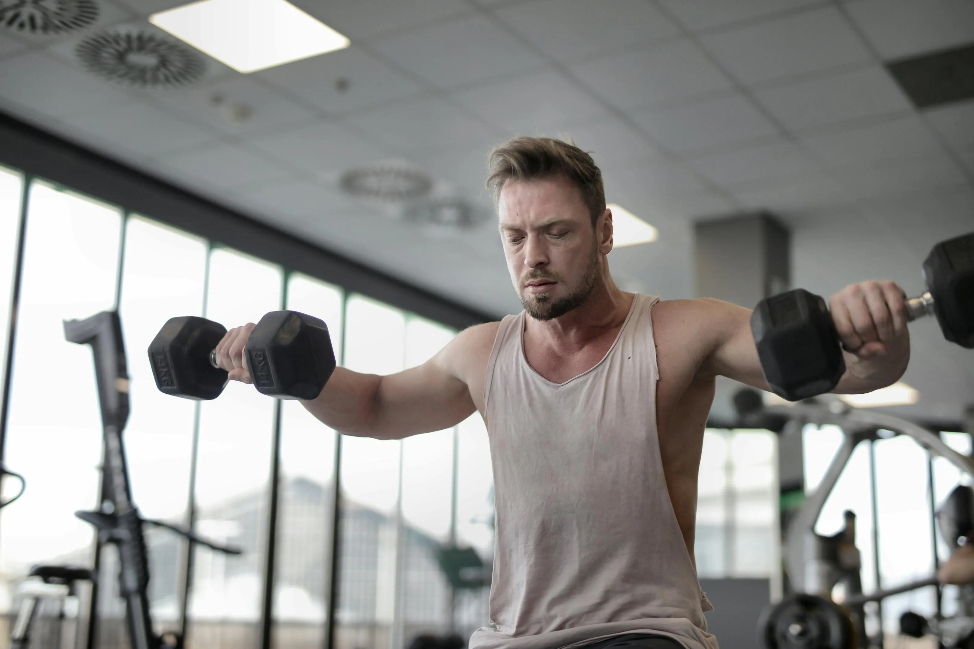 Man Holding Dumbbells During Workout Download Free Wallpaper