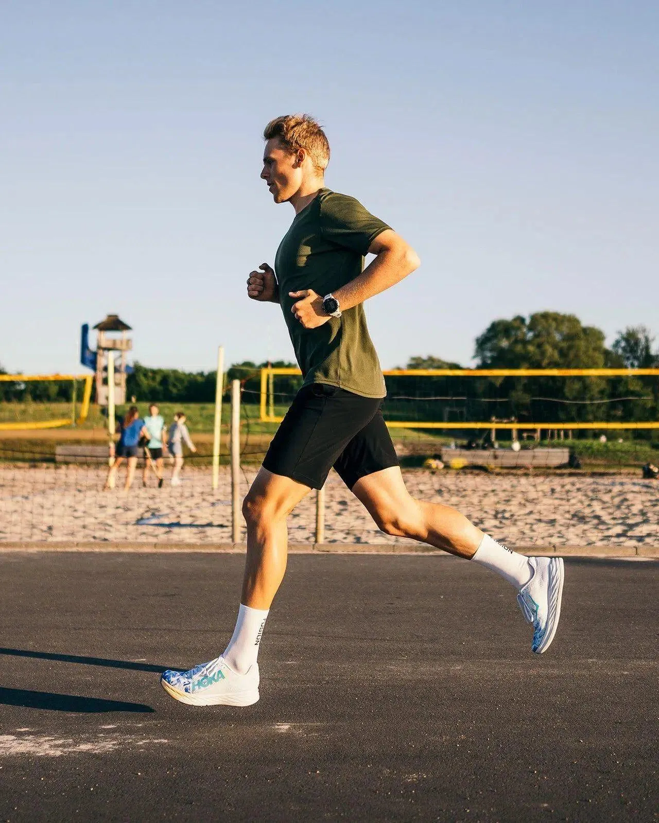 Man Jogging Outdoors on a Sunny Day in Sportswear Wallpaper