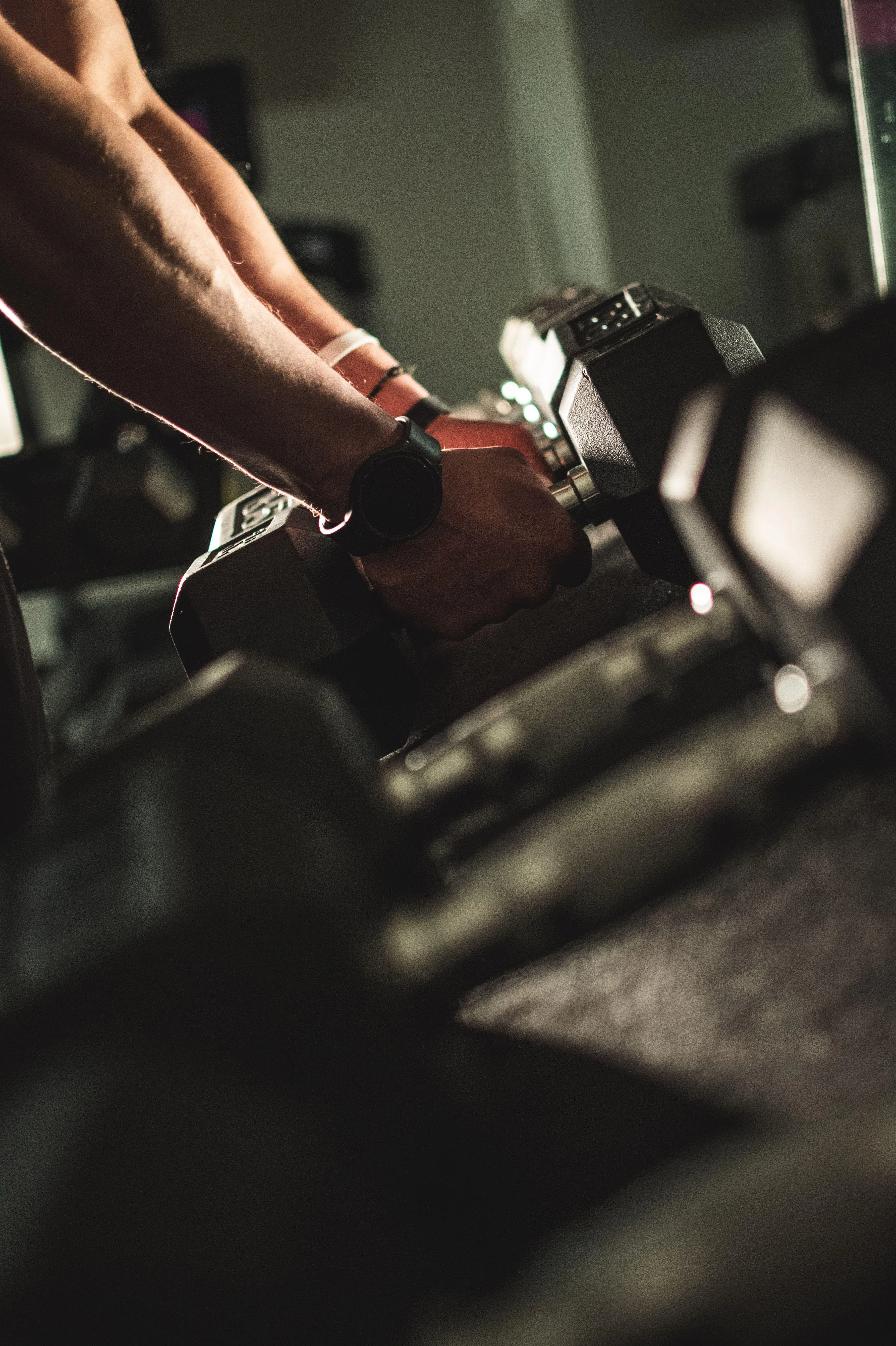 Man Lifting Dumbbells During Intense Strength Training