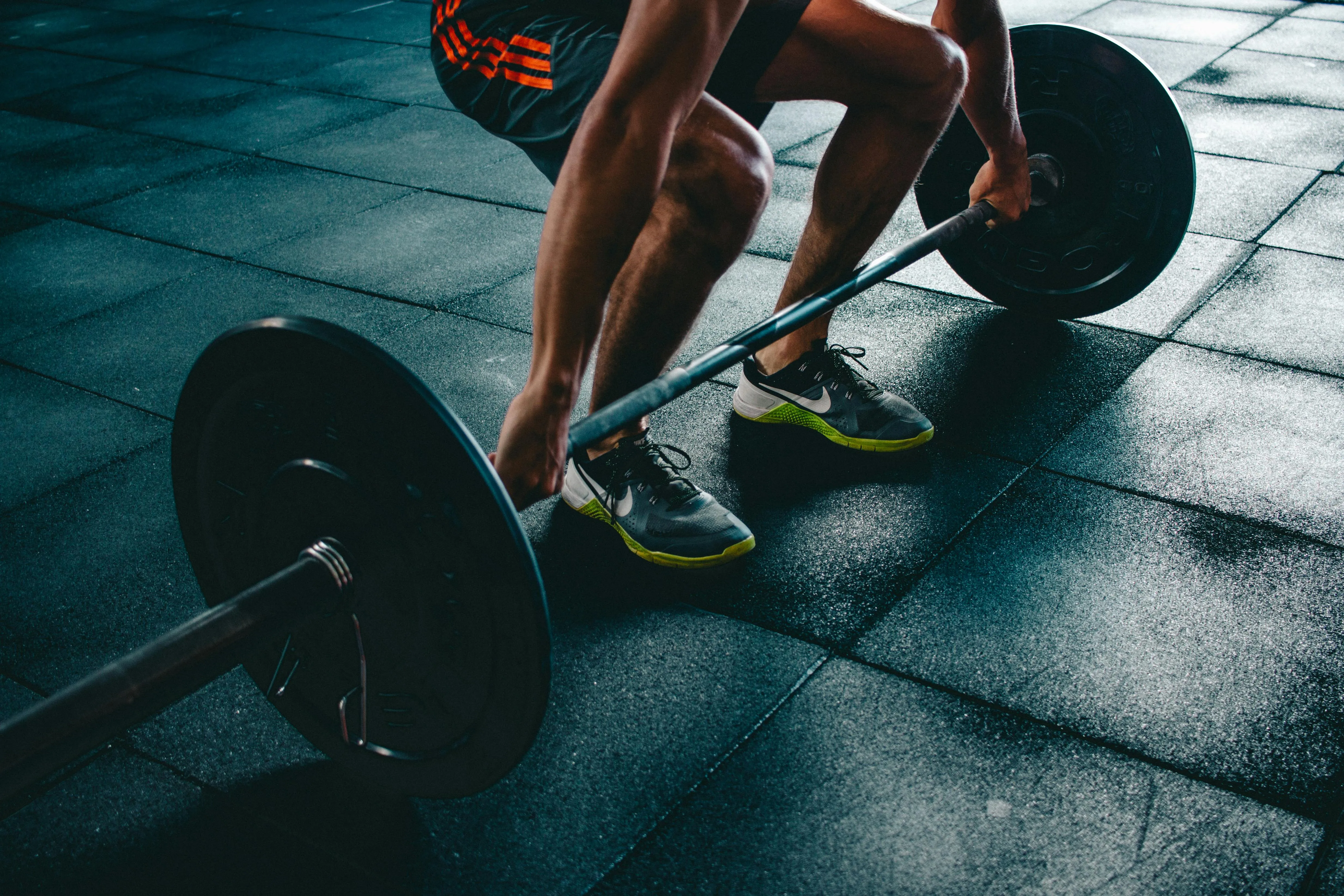 Man Lifting a Heavy Barbell in the Gym During a Workout