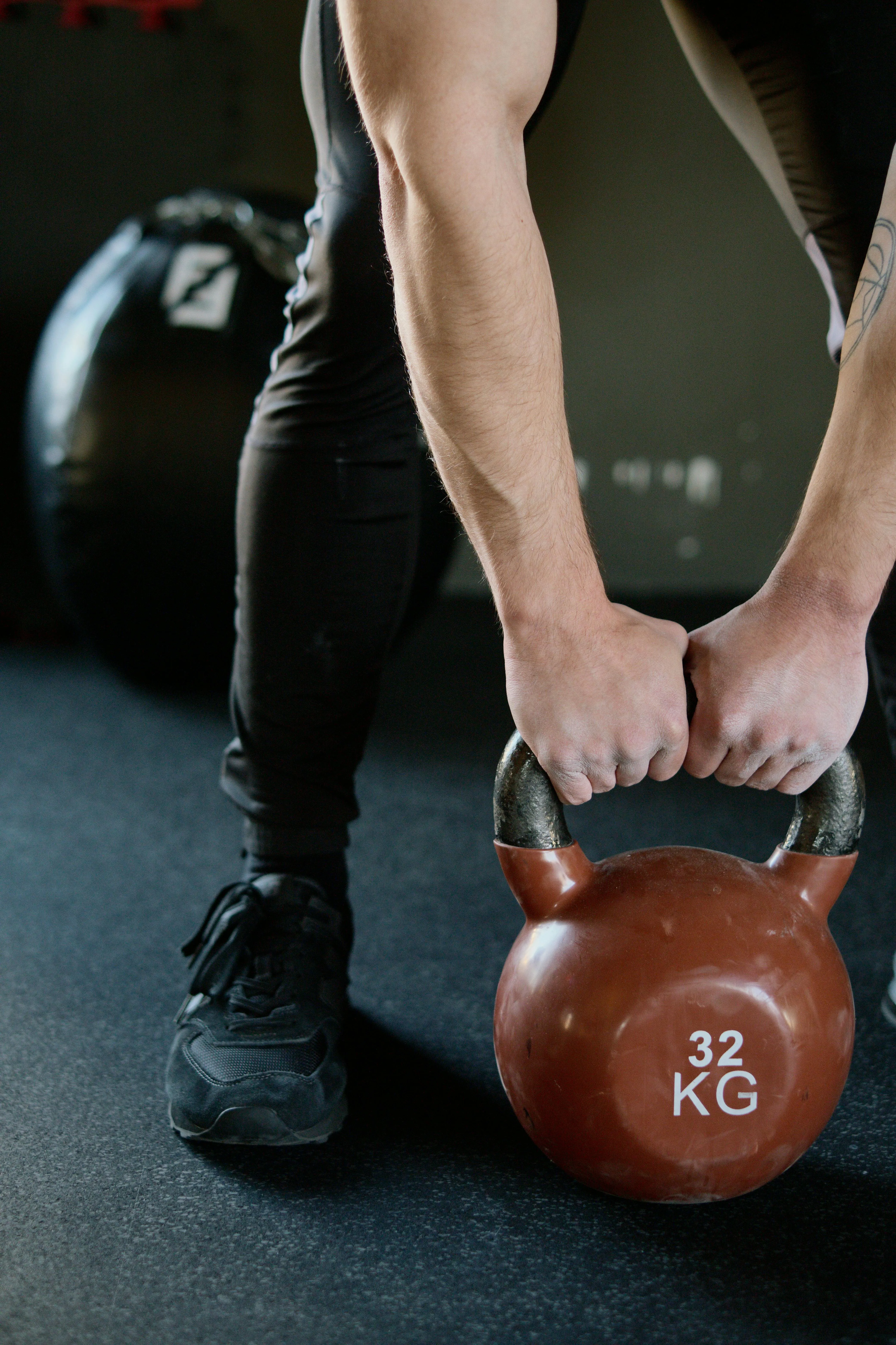 Man Lifting a Heavy Kettlebell During an Intense Gym Workout
