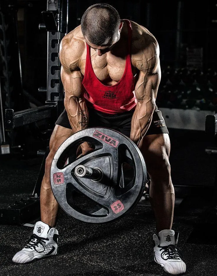 Man Lifting a Heavy Weight Plate in an Intense Gym Workout