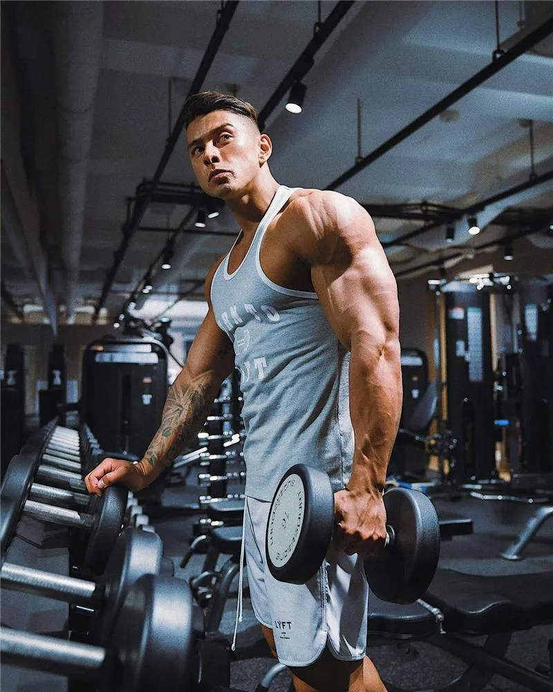 Man Lifting Heavy Weights During Focused Gym Workout Session