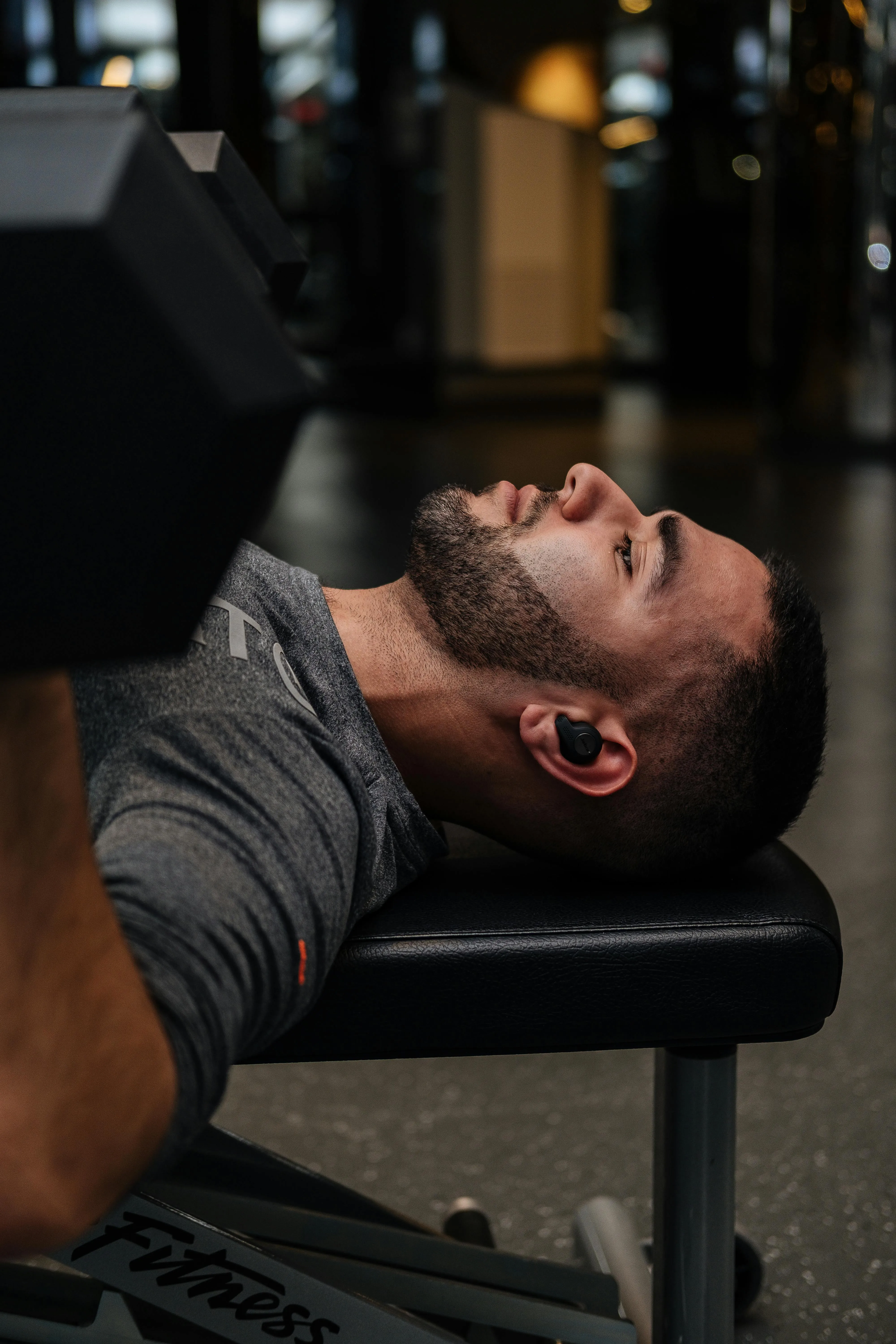 Man Lying on Bench Preparing For Heavy Weight Lifting