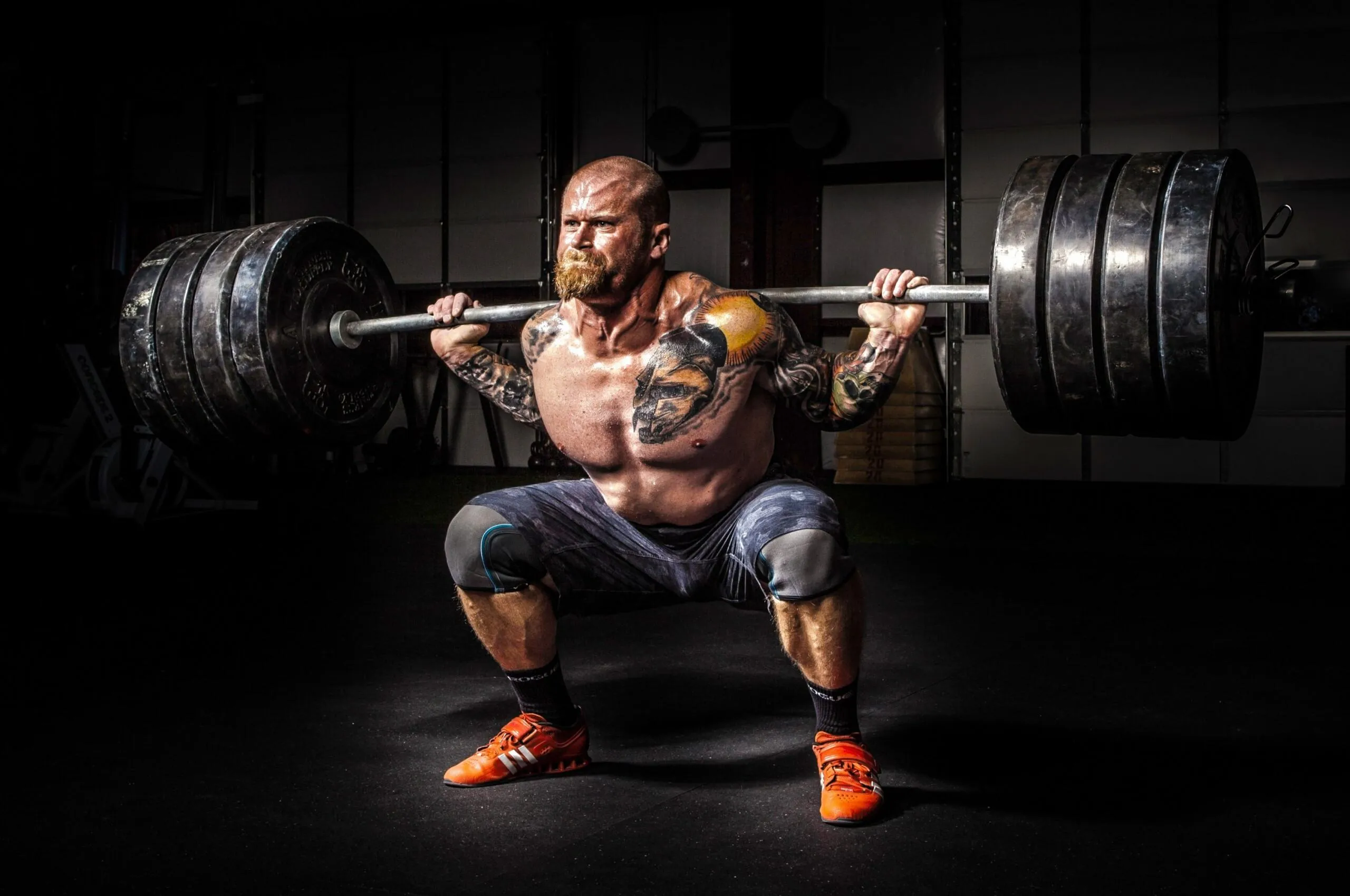 Man Performing a Heavy Barbell Squat For Strength Training