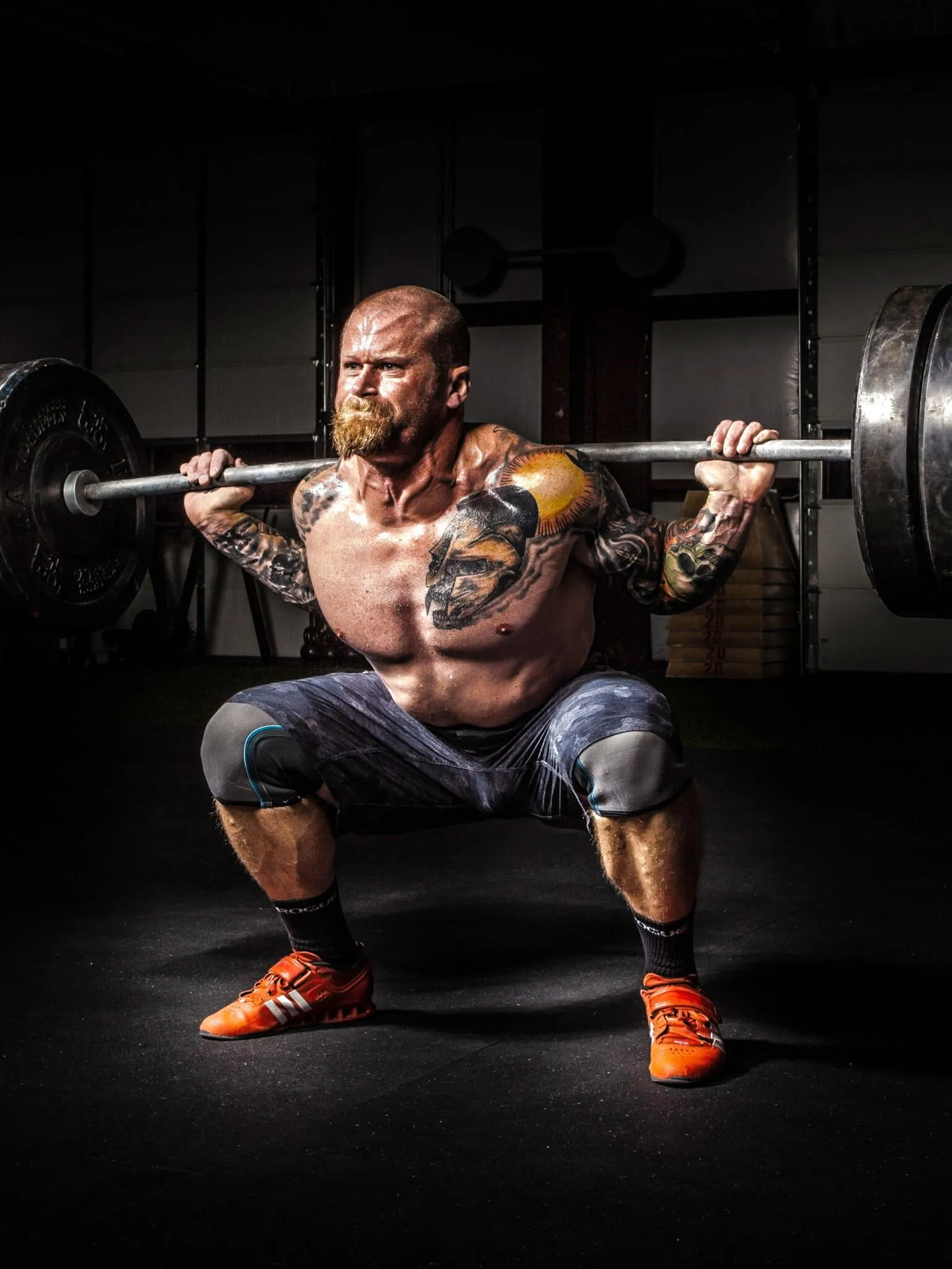 Man Performing Intense Heavy Back Squat With Barbell Weights