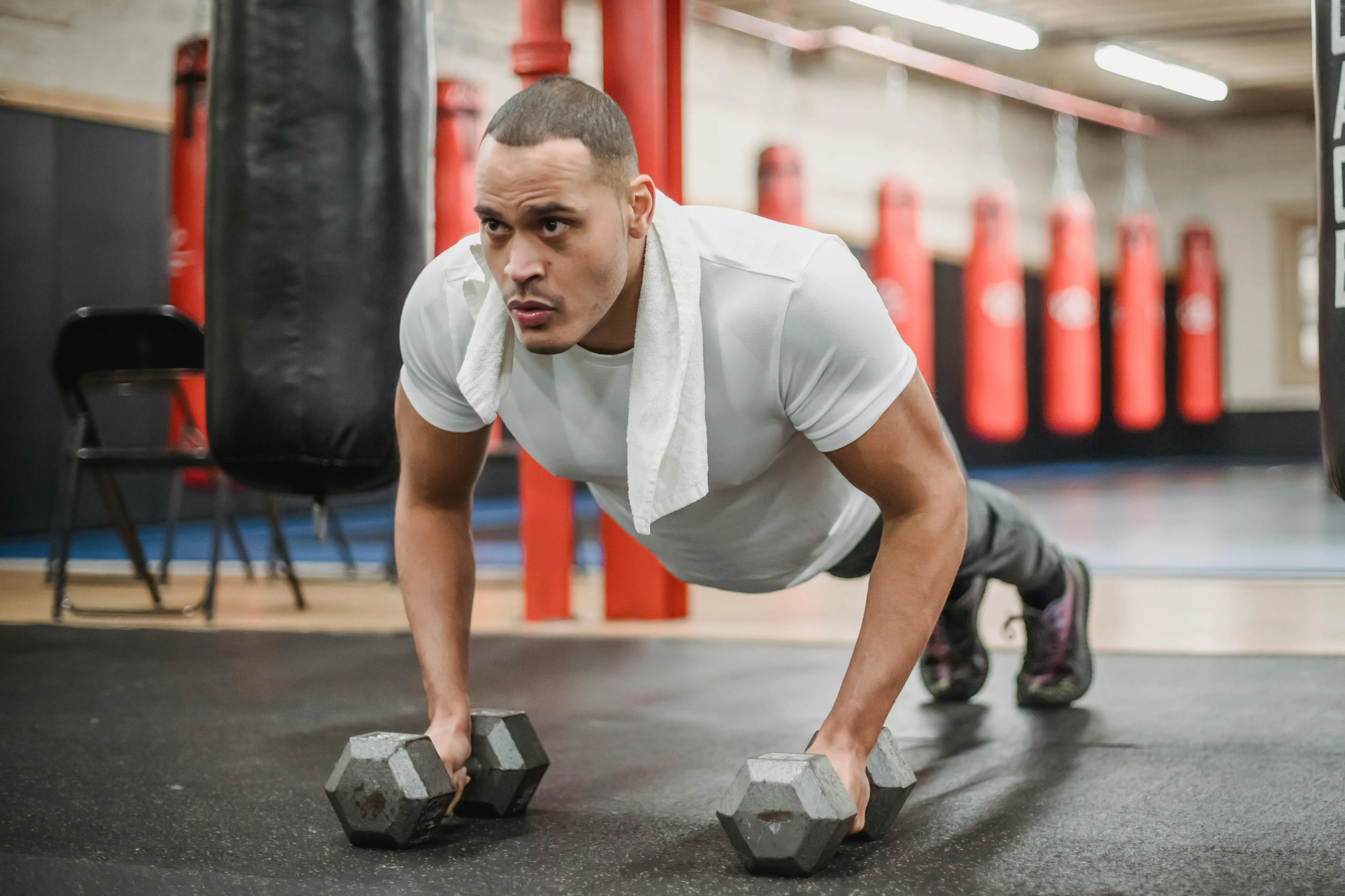 Man Pushing Up With Dumbbells on a Floor Free Hd Wallpaper