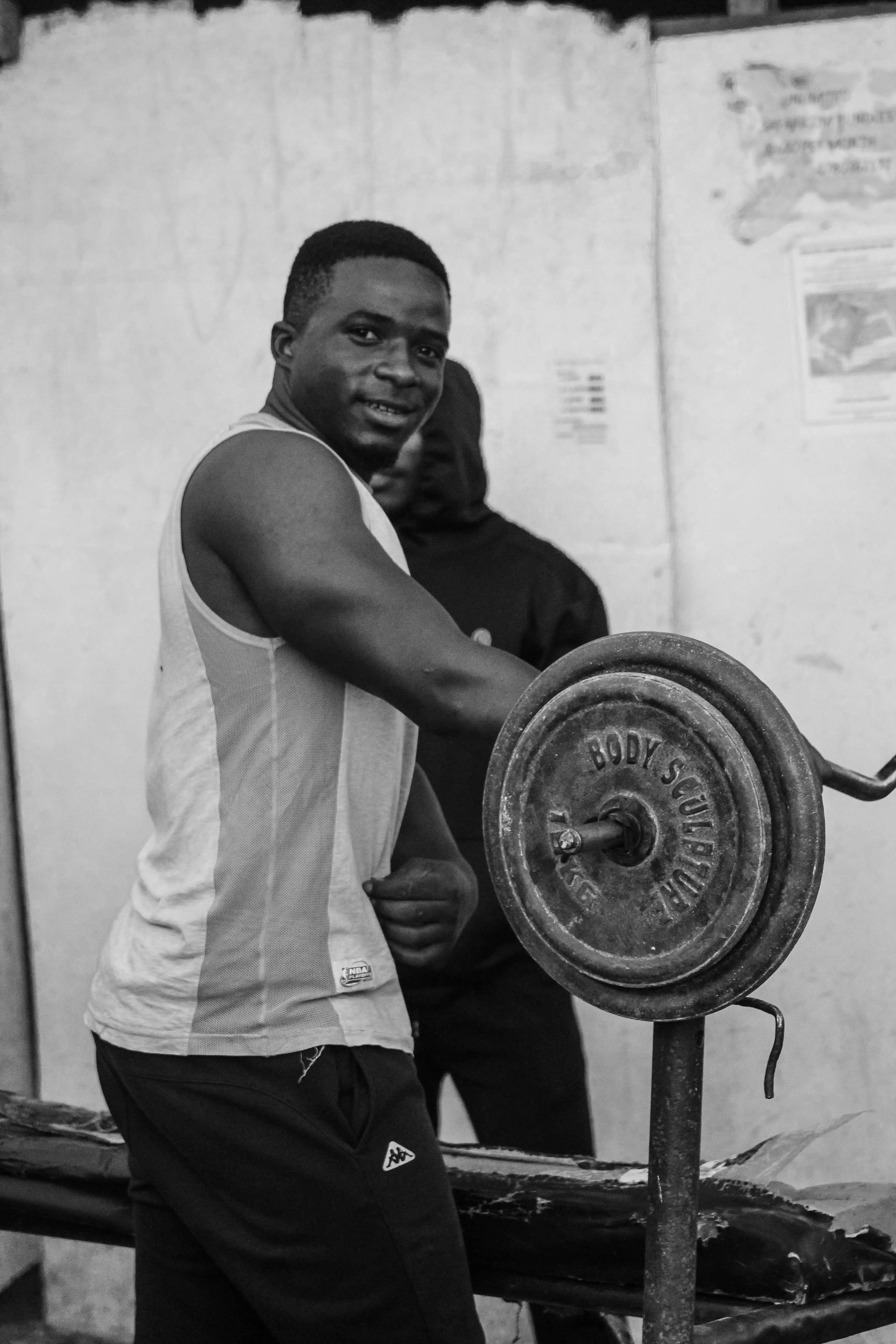 Man Resting on a Barbell After Intense Strength Training