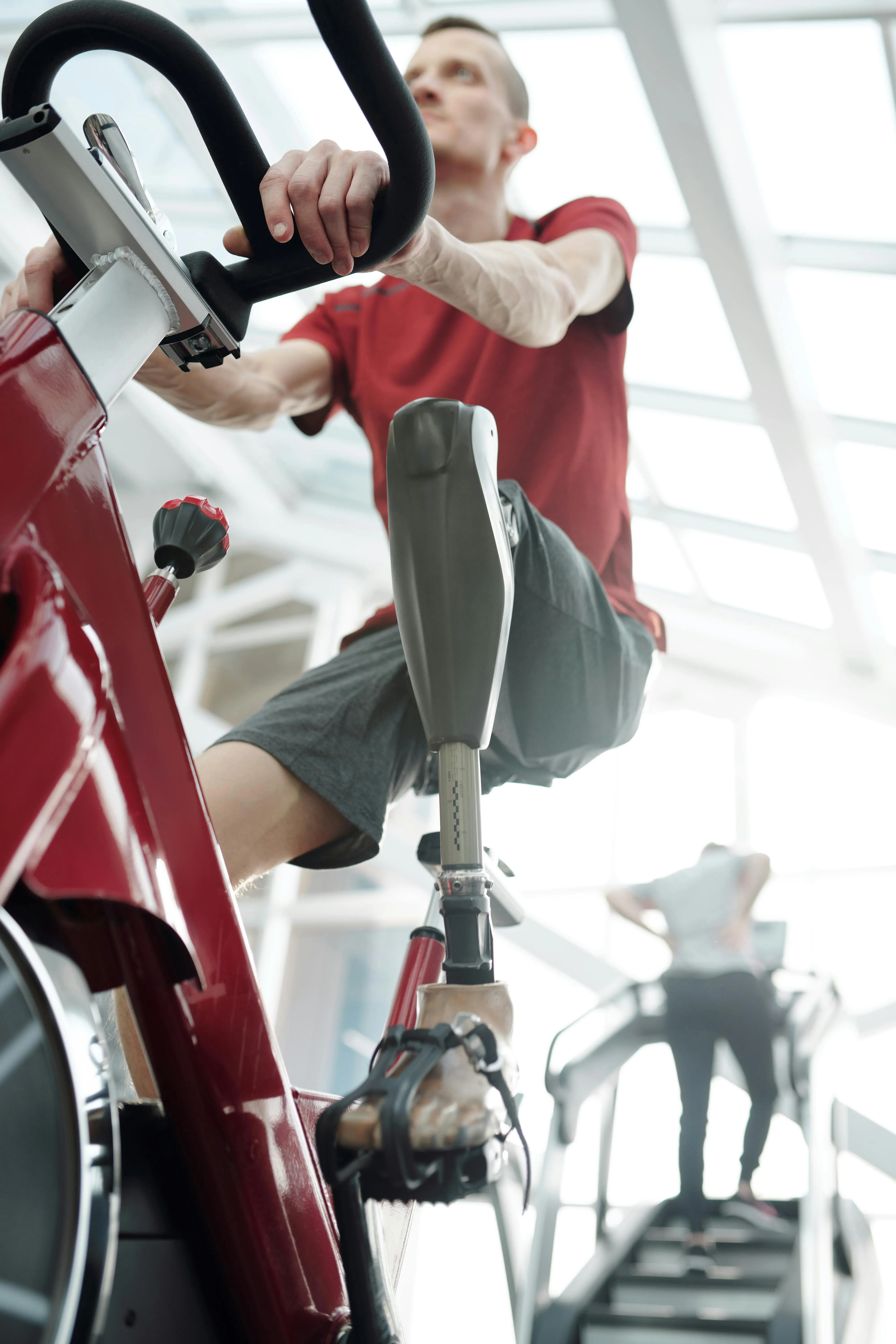 Man Riding a Stationary Exercise Bike With Red Jacket
