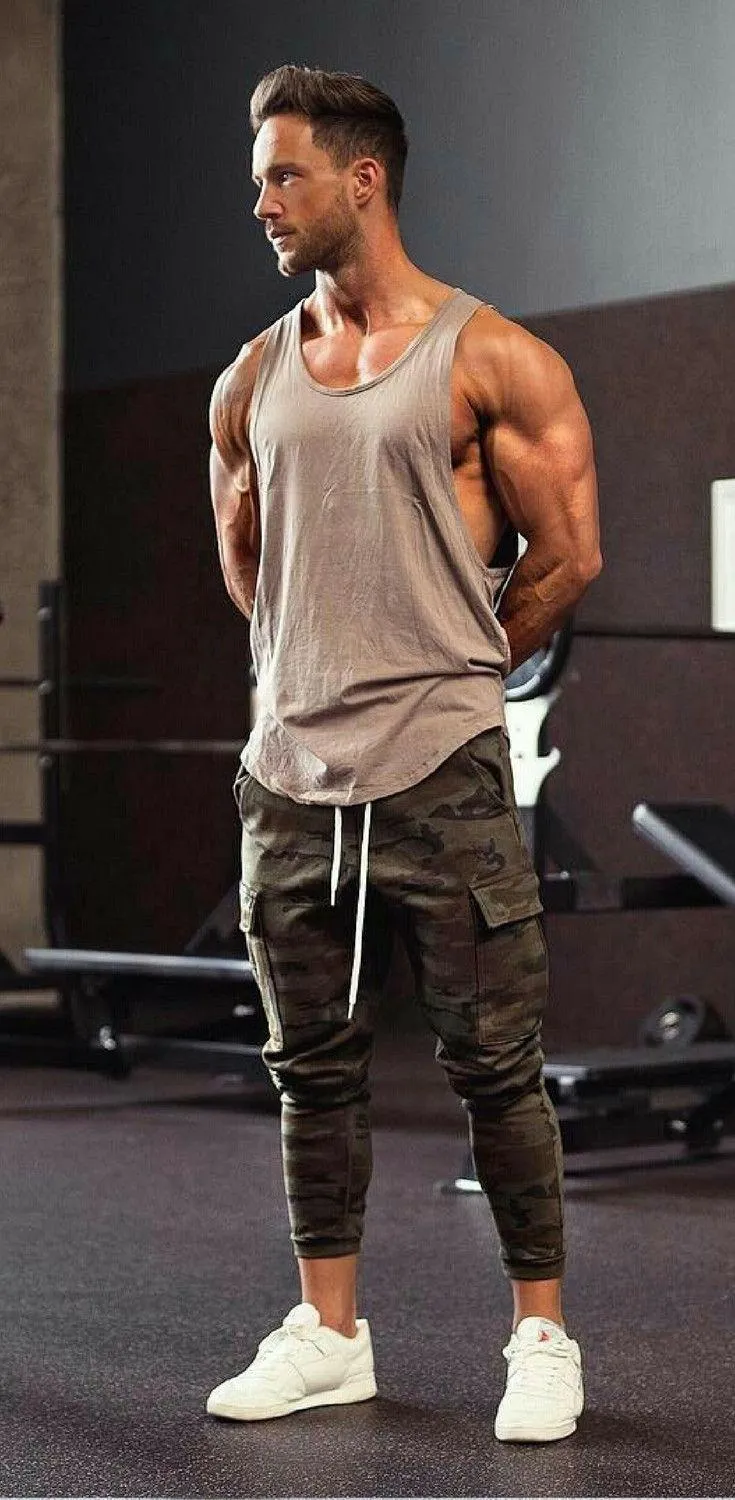 Man Standing in the Gym Wearing an Athletic Tank and Joggers