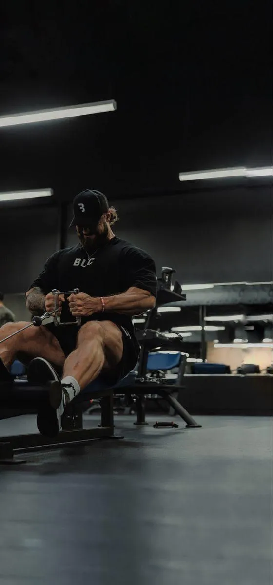 Man Using a Gym Machine During Focused Leg Training Session